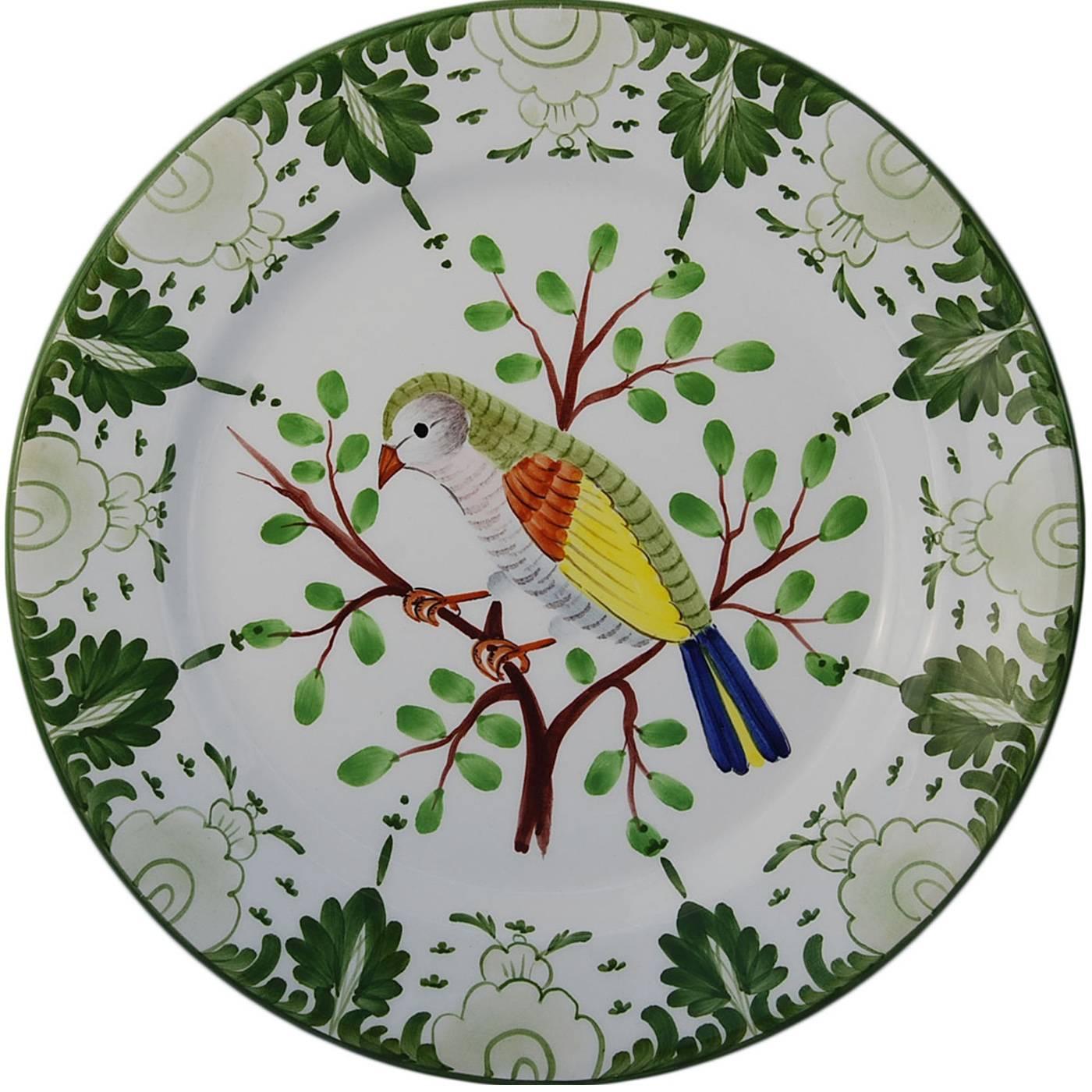 Hand-painted colors on a white background depict birds on leaves in this collection of six ceramic earthenware plates by historic Italian house Este Ceramiche. Each bird is depicted in different form and movement giving the dinner table a very