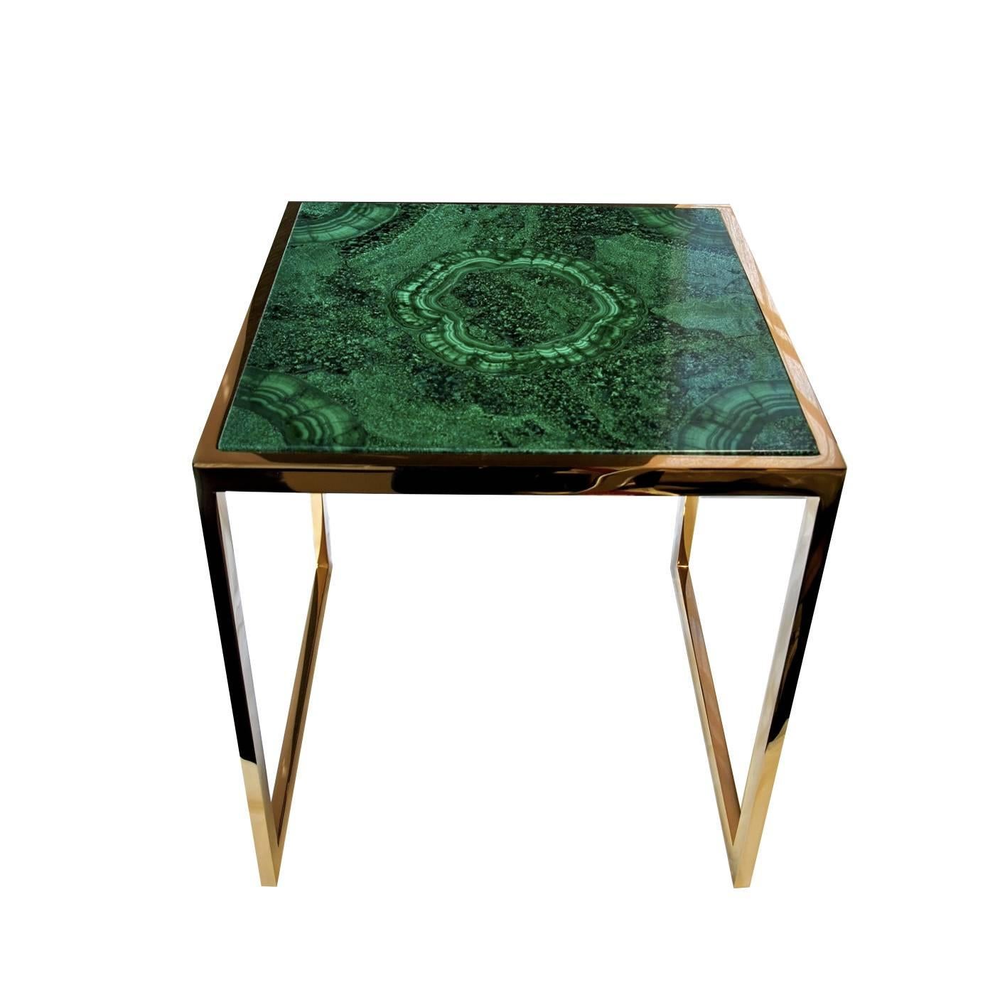 This side table appears small and delicate at first until the striking, natural hand-cut malachite top is observed. This striking stone features a variety of striations in shades of green, spanning from light to dark and everywhere in between. The