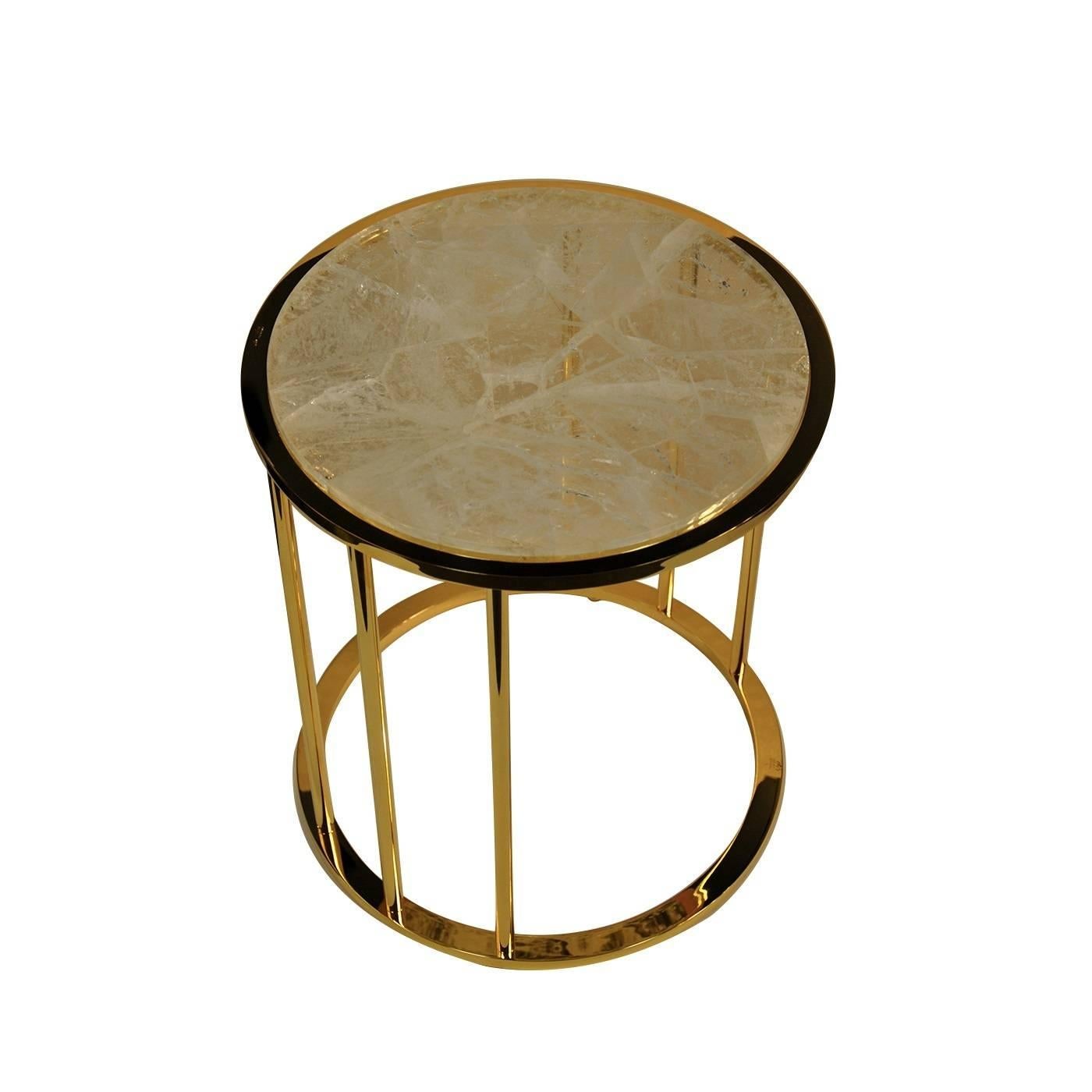 This elegant handmade side table will make a sophisticated addition to a living room or bed room with its Minimalist structure in nickel-plated brass with a lustrous gold finish, holding up its round sliced Brazilian hyaline quartz top. This