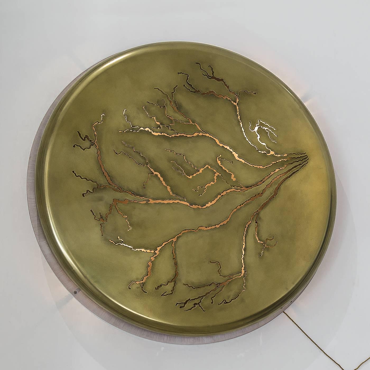 This exquisite wall lighting sculpture bares a striking design resembling lightning. This one-of-a-kind piece features a base crafted in glazed, plasma-cut aluminum with a top in wax-coated with brass plating giving it a warm glow. That projects the