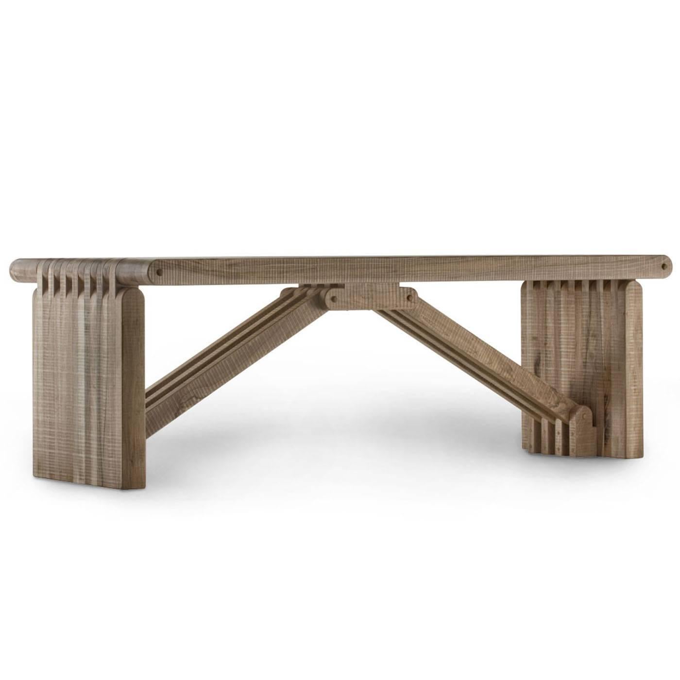 The structure of this exquisite table in Italian walnut is assembled with visible joints and pins and its surfaces are hand planed. The snap-fit technique with which this unique furniture object is obtained allows to create complex and strong