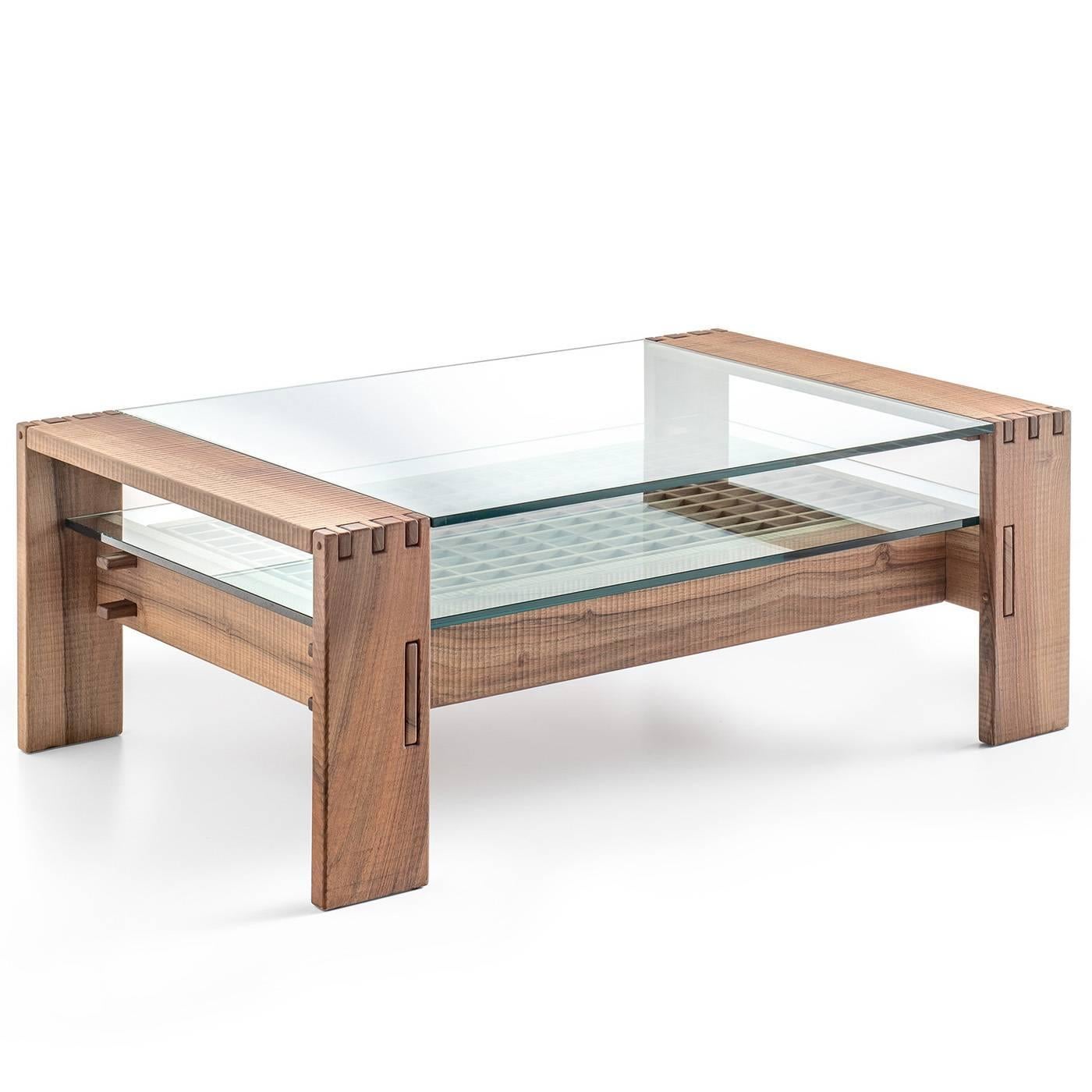 This elegant coffee table with drawer is entirely made in Italian walnut wood and hand-finished with a plane. The structure features interlocking pieces of wood with visible points and pins and a glass top that covers the bottom of the table