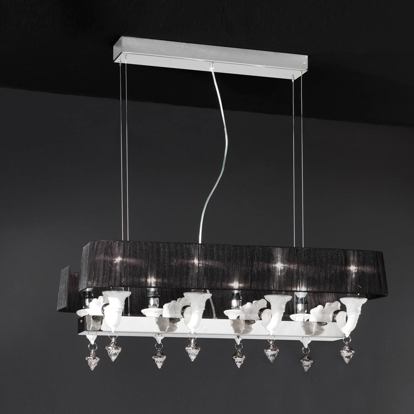This handmade ceramic chandelier features both modern and Classic elements making it ideal to elevate any environment in which it is placed. The refined and Minimalist shape of the center element in chrome is complemented by the four contrasting