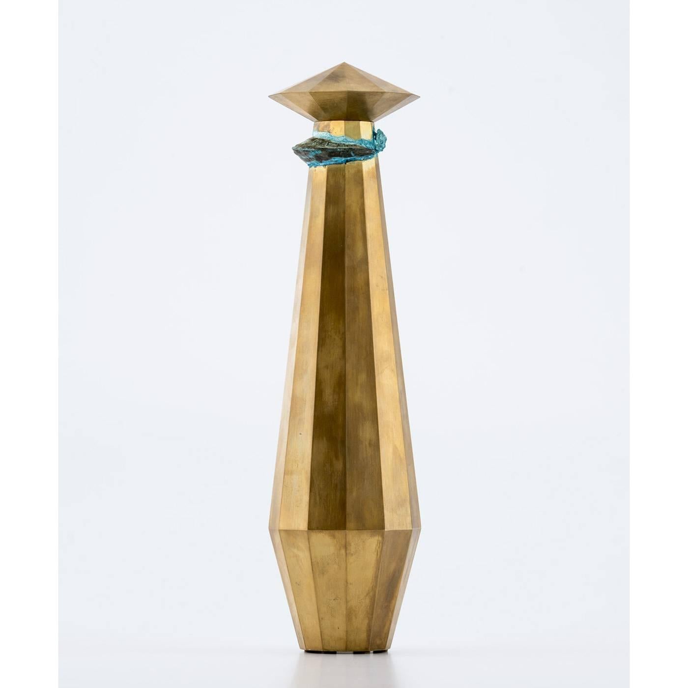 The sharp edges of the hand-oxidized brass plates comprising this vase are shaped to geometric perfection by a CNC milling machine. At the top which tapers, a hand-hammered copper insert is imbedded into it, adorning its the surface. The irregular