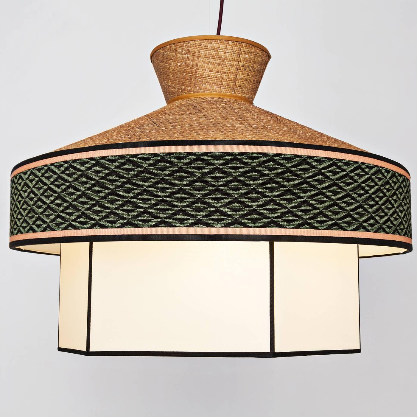 This chandelier is part of a limited series of 12 pieces designed keeping the eclectic style of the Milanese restaurants of the 1950s in mind. In this piece, a structure in rattan comes together with fabric decorated with geometric patterns, to