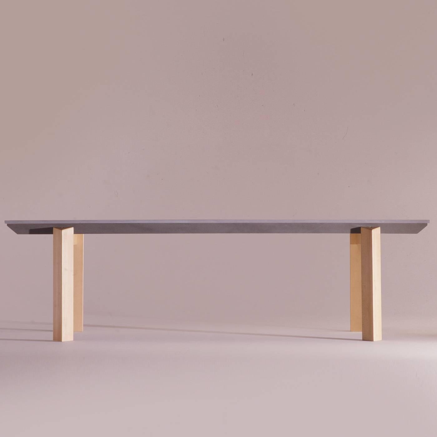 The stone T for this tabletop is highly customizable in terms of length and weight. This table can be taken apart. The two outside 'T's are structural and connected to the legs in tinted beech wood. The two inside 'T's are simply resting on the