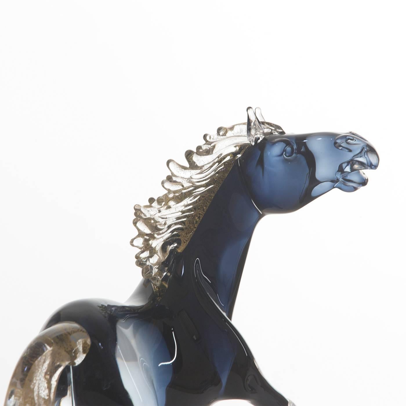 This exceptionally animated small sitting horse is entirely handmade by the master glass blower Zanetti on the island of Murano in Venice. The mane, tail and hooves have 24-karat gold details, while the shaded black glass of the body features subtle
