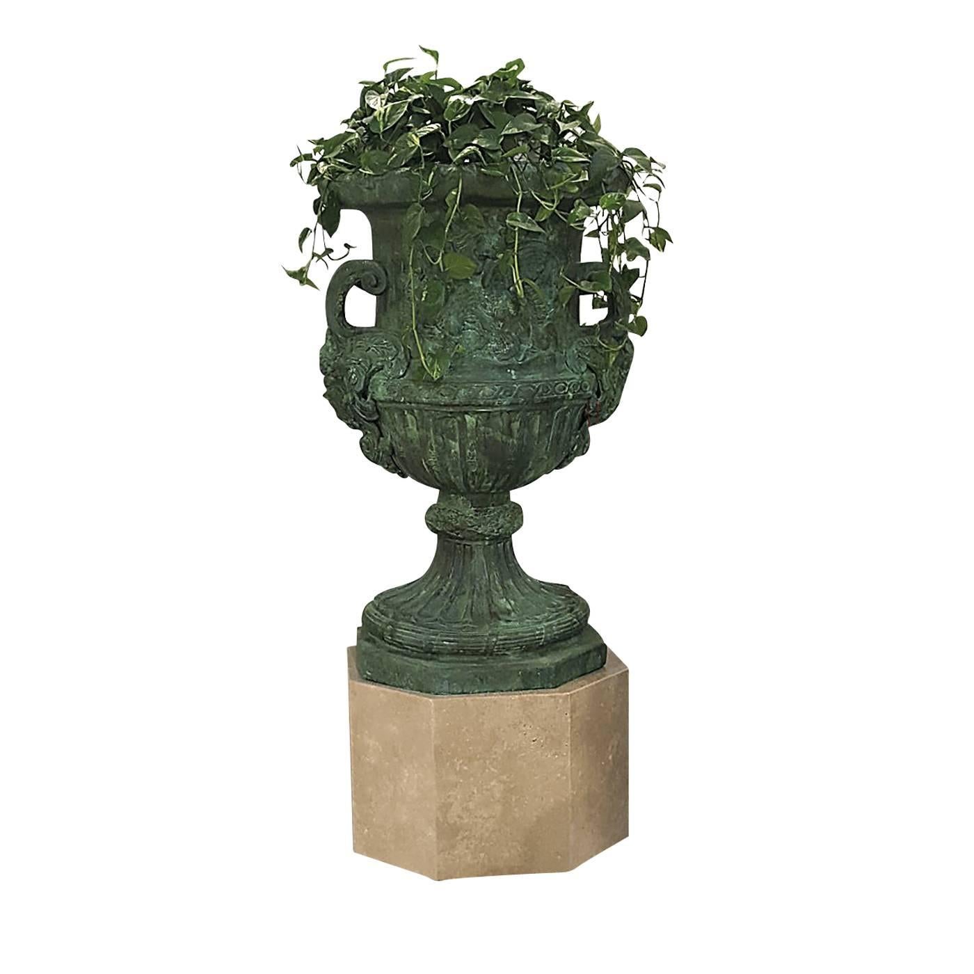 This exquisite decorative object rests on an octagonal travertino marble base. The Amphora is made in bronze with the lost-wax casting technique and has a charming green patina that adds a timeless allure to its Classic shape. This piece can be used