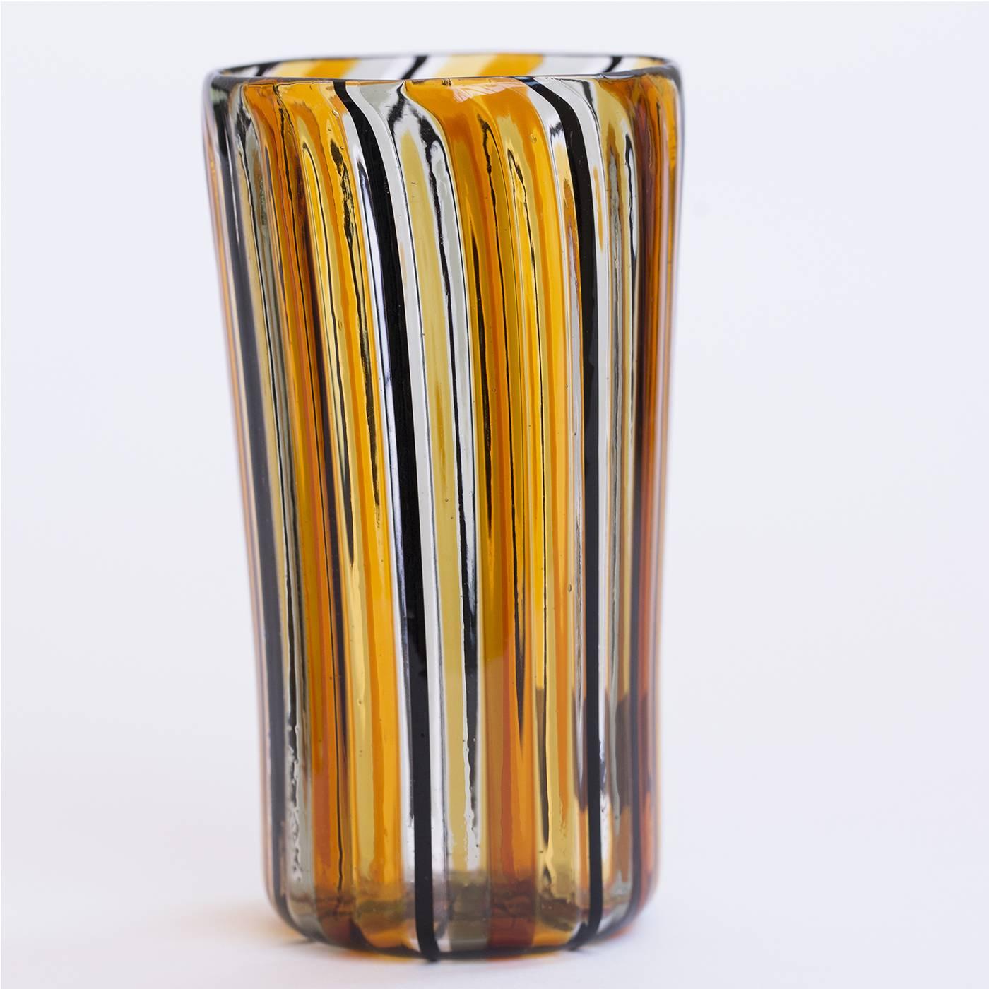 Set of 12 Murano glasses made with the 'a Canna' technique, where canes of colored glass are melted into a clear glass base. This beautiful amber and black set includes six water and six wine glasses entirely handcrafted on the Venetian island of