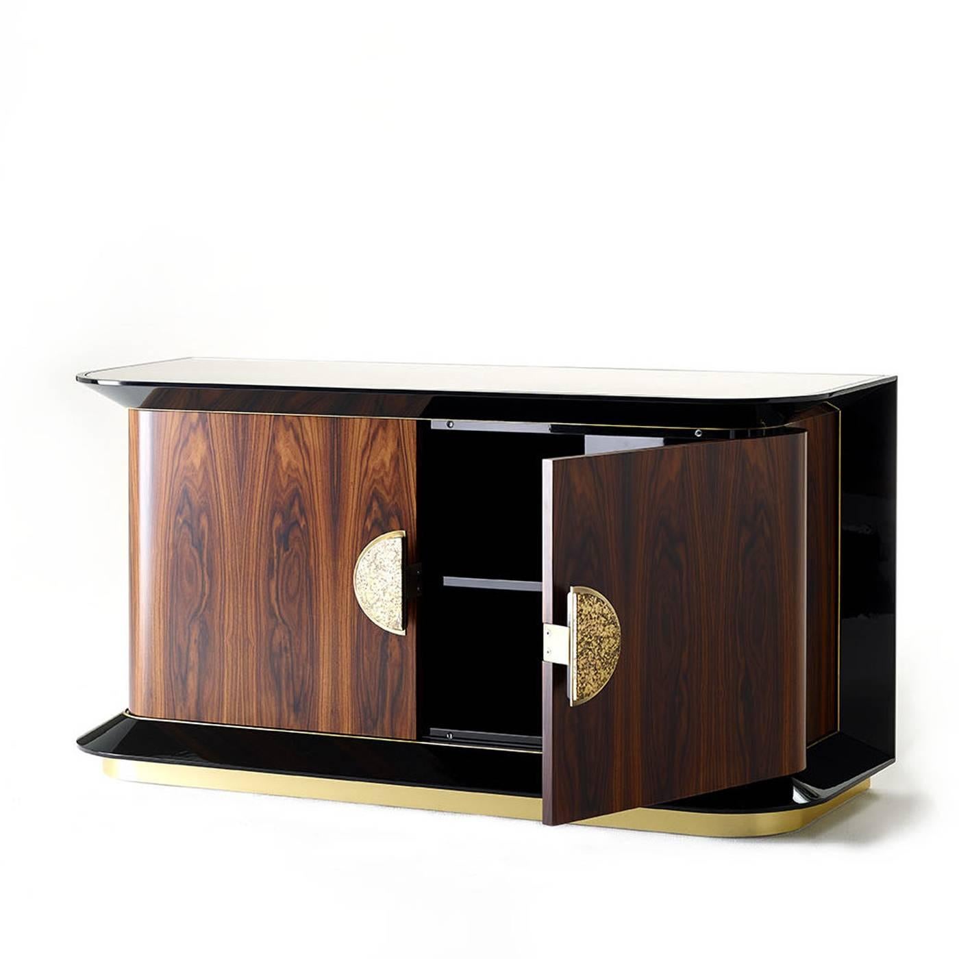 A lavish sideboard, designed by Studio 63 for Marioni, with double doors and ceramic elements in the middle and a glossy black wooden frame. The interior is done in a contrasting color, but this piece is also available in different finishings and