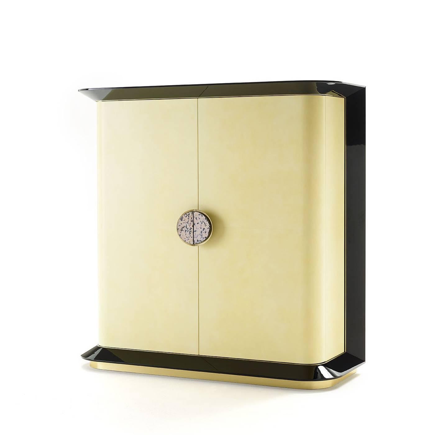 This elegant and functional yellow top cabinet designed by Studio 63 for Marioni features double doors lined with parchment and ceramic decorative elements and a perimeter structure in black glossy wood.