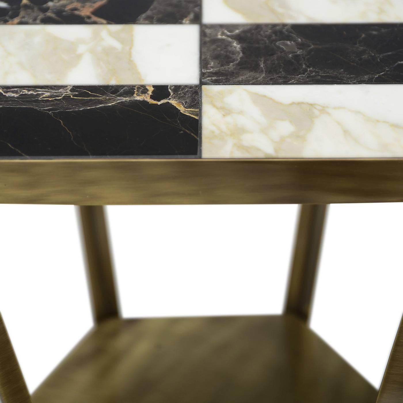 The structure of this striking coffee table is a brass hexagon supporting the marble top with the help of six elegant brass legs. This piece is available in several configurations of finishes and marbles. In this case the brass structure supports a