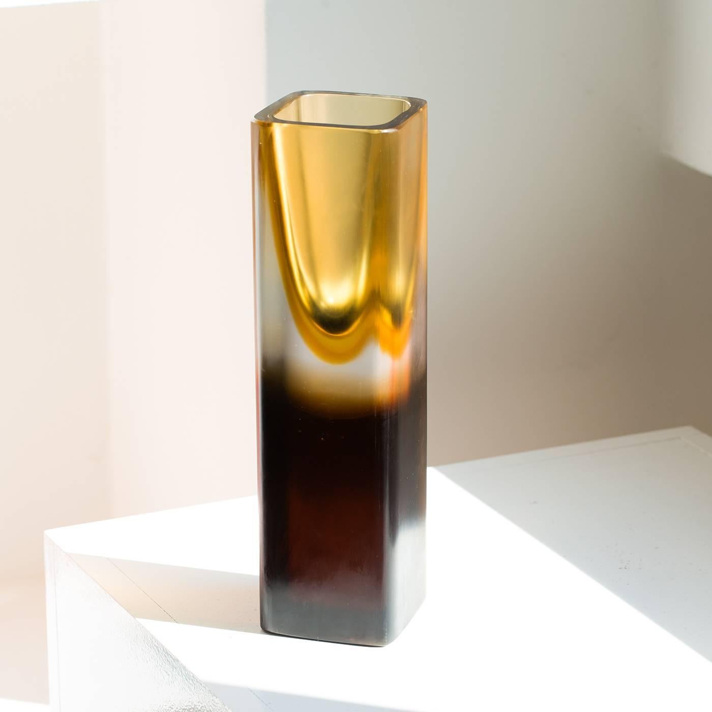 This exquisite mouth-blown, handcrafted vase is made up of two elements: an ethereal amber-colored top rests on a solid dark base. This unique piece is hand finished with a diamond grindstone for a silk-like, uniform surface.