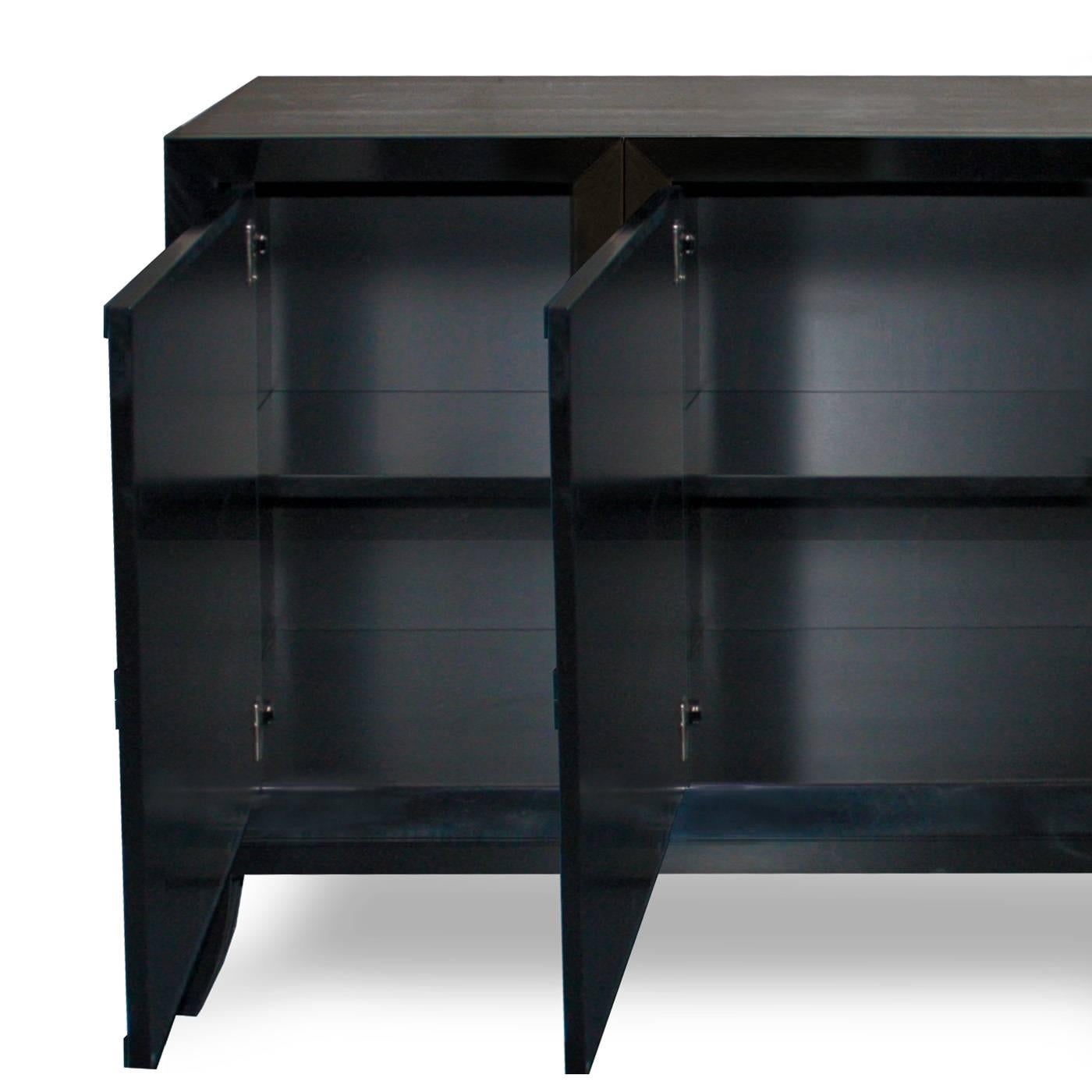This four-door sideboard, is beautifully crafted by the finest Italian artisans and is finished in a hard, super sleek black gloss lacquer. The black and white finish and the wooden rhomboid-shaped handle add drama and sophistication.