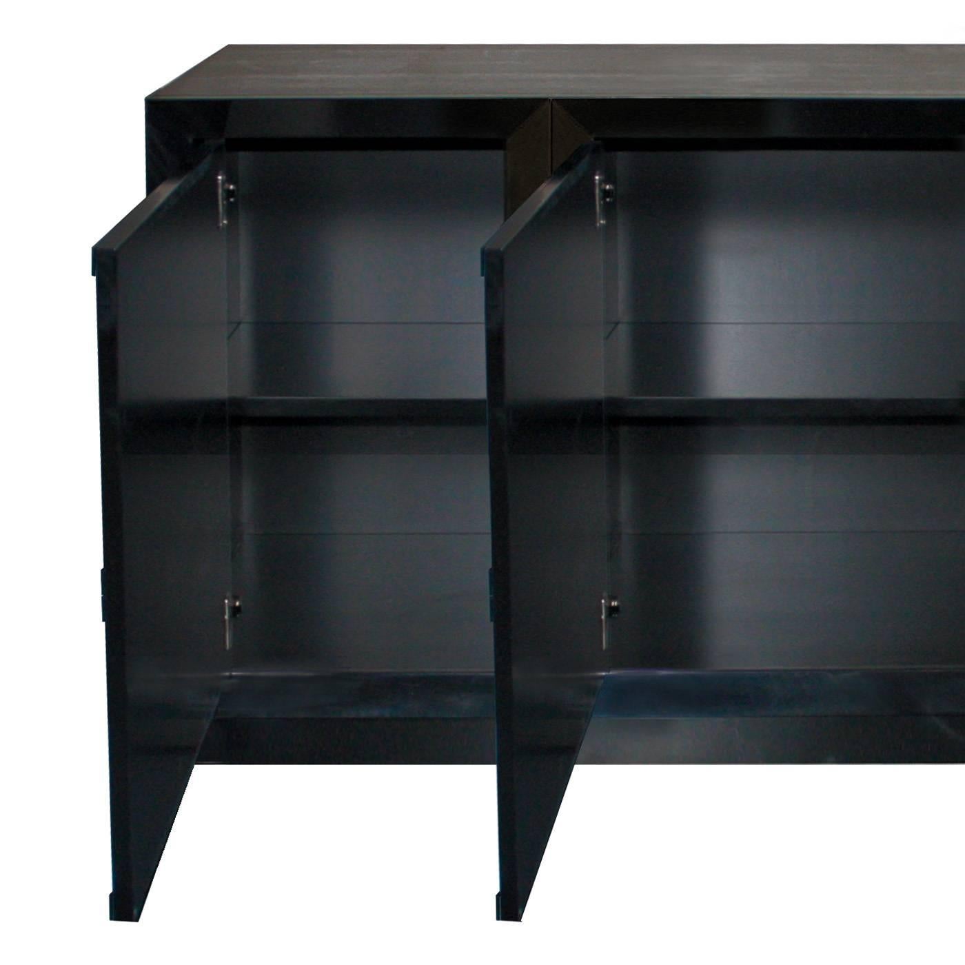 This four-door sideboard is beautifully crafted by the finest Italian artisans and is finished in a hard, super sleek black gloss lacquer. The black and white finish and the wooden rhomboid-shaped handle add drama and sophistication.