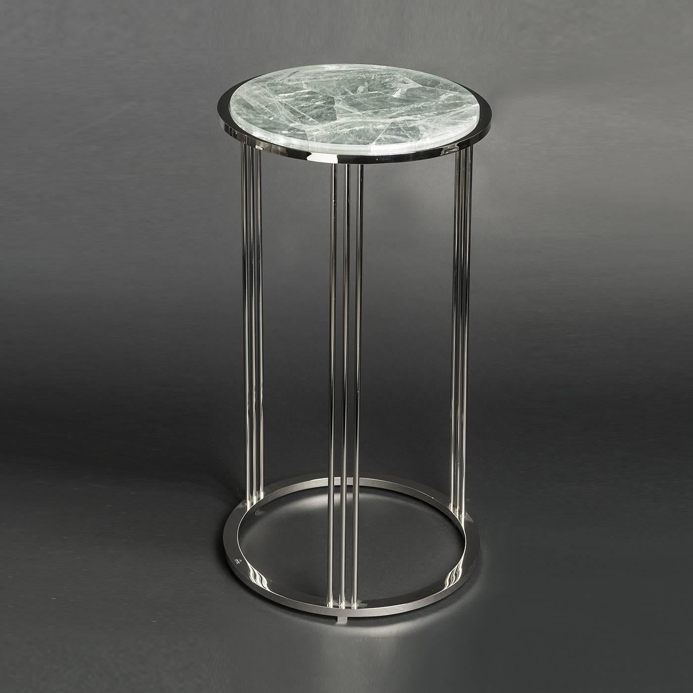 This side table has an elegant yet simple shape comprised of a structure in brass with lustrous nickel plating and a round top in-bedded into the frame in cut Brazilian hyaline quartz. This piece is entirely handmade. The size and metal color of