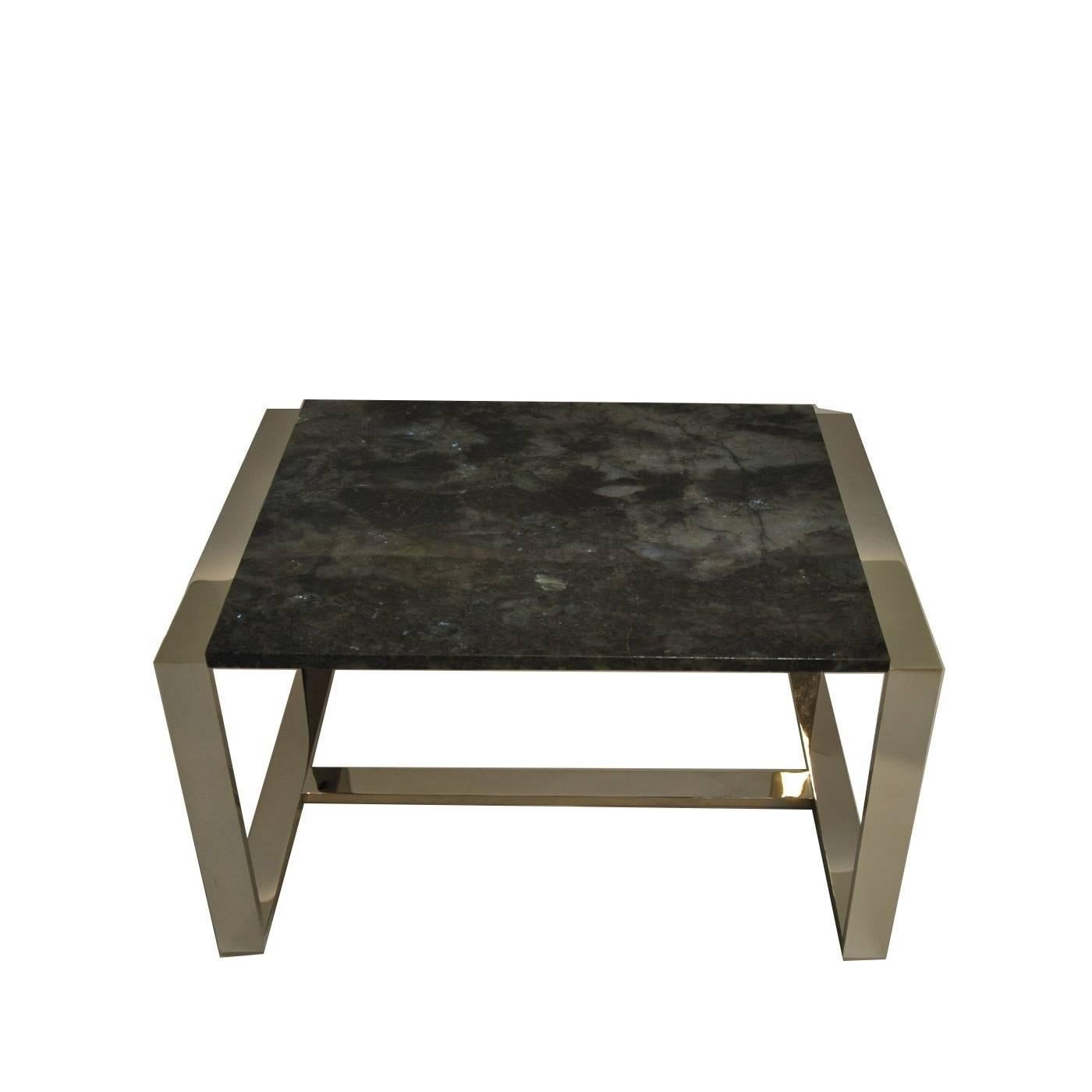 This spectacular coffee table combines natural materials, hand-cut in their original form, and man-made components creating a piece that is the perfect balance of the two. The top of this table is a striking rectangular piece of labradorite from