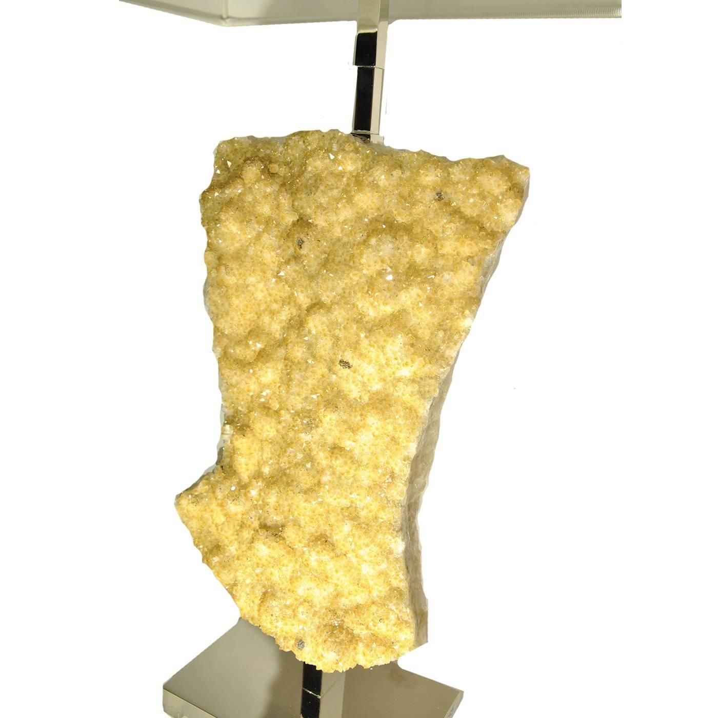 This table lamp doubles both as a functional home accessory and as a decorative sculptural piece that will enhance the decor of any room in the house. The body of this lamp was crafted using a large piece of hand-cut thermo diffuse citrine from