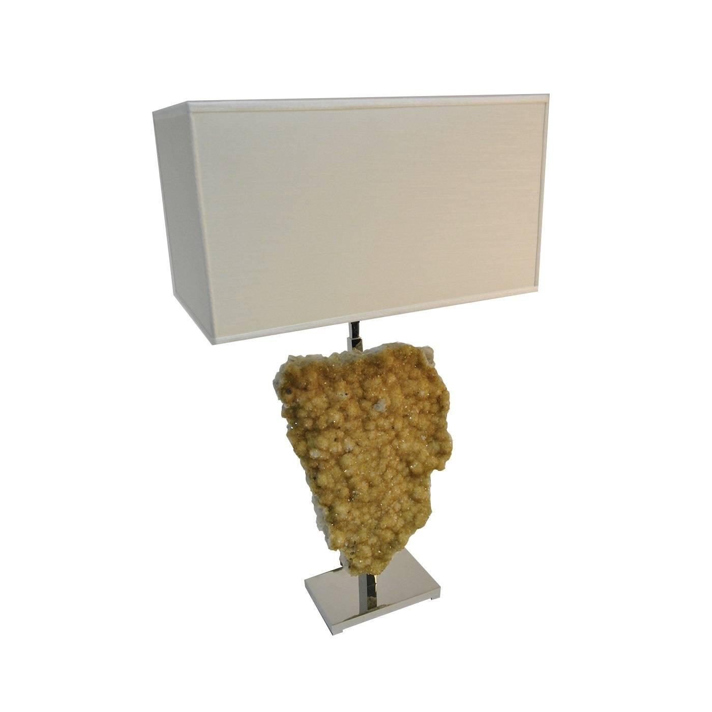 Having this jewel displayed in your home will immediately elevate the interior and ambiance of any room. The body of this exquisite lamp is crafted entirely from a hand-cut natural piece of Thermo Diffuse Citrine. The creamy white shade reflects the
