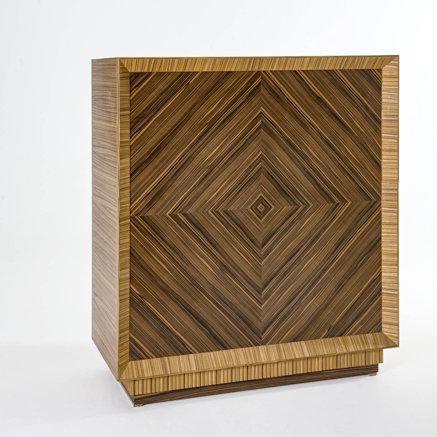 This unique chest of drawers will make a statement when placed in a bedroom or walk-in closet. The exterior structure is crafted in solid wood with a striking zebra-striped pattern. The front and back of the piece are in ebony Macassar wood with a