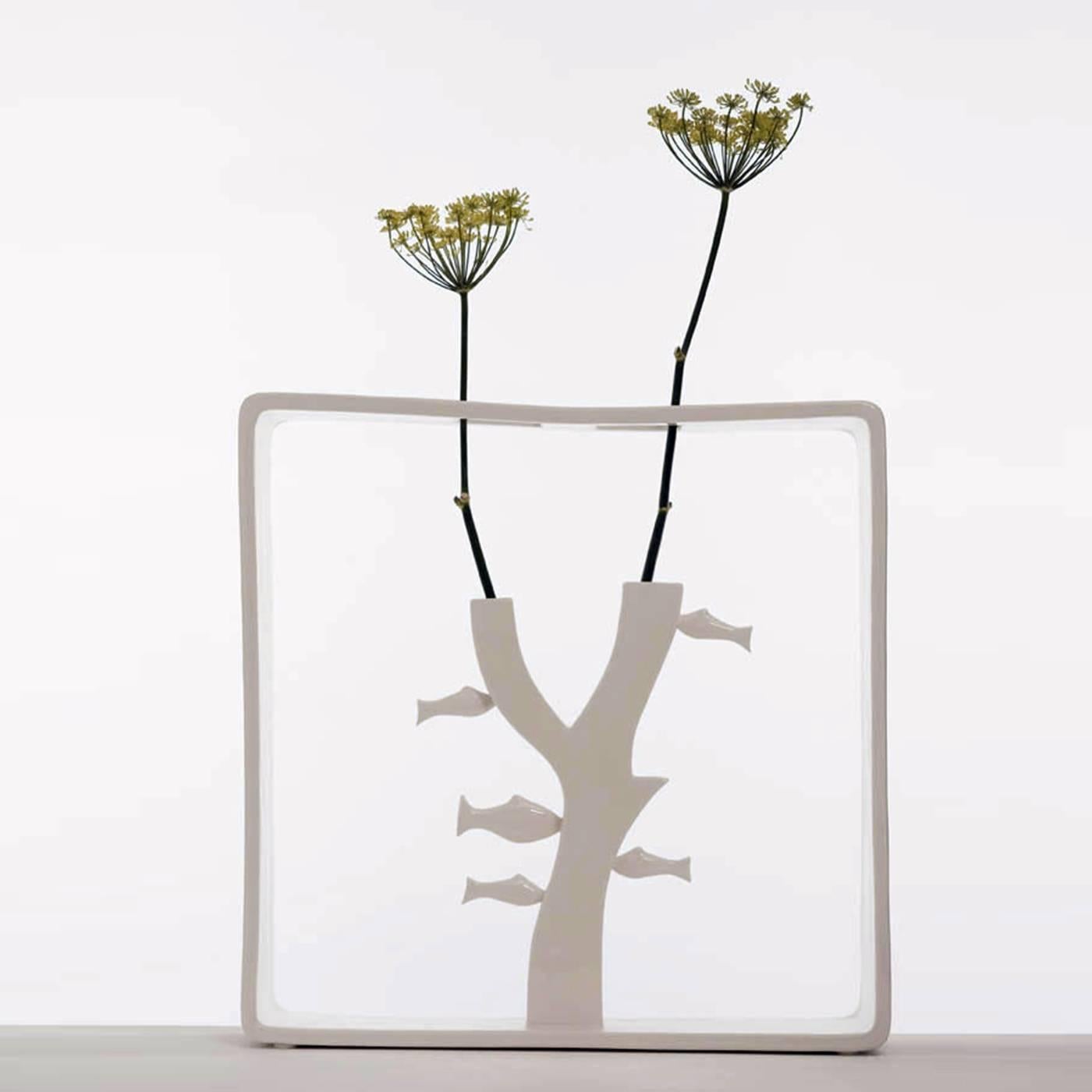 Part of the collection Portali by Andrea Branzi, featuring 18 vases made in white ceramic, this piece creates a micro-environment ready to host two stems of flowers. This vase is part of a limited series of 50 pieces, all signed and numbered and