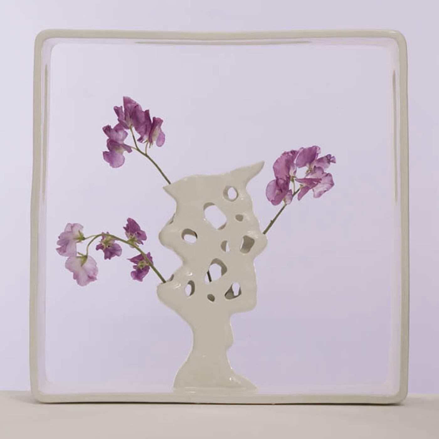 Designed by Andrea Branzi as part of the collection Portali, this vase is one of 18 designs that create micro-architectures enclosed in square spaces to host floral arrangements to be placed anywhere in the house. This is part of a 50-piece series