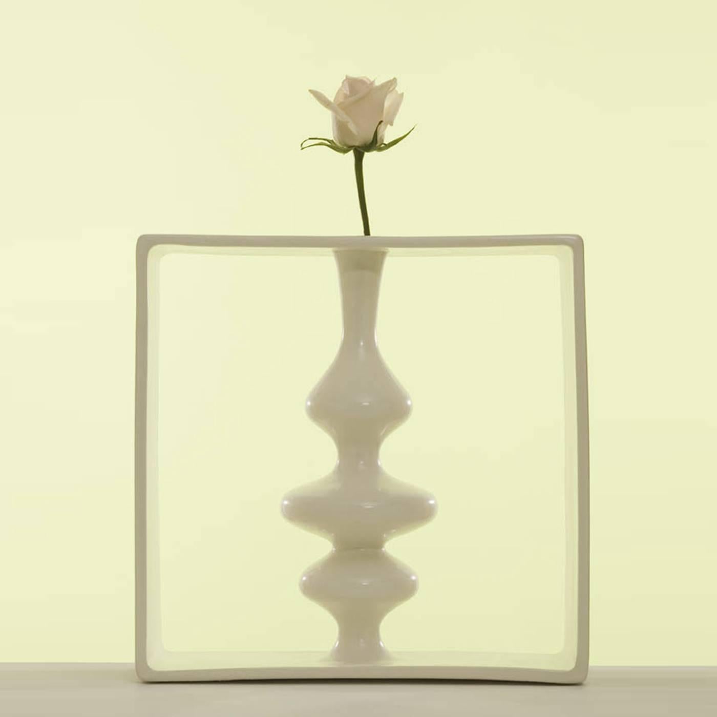 This delicate white ceramic vase was designed by Andrea Branzi for Superego and is part of a collection of 18 vases, all encapsulated within a frame. This design is part of a limited series of 50 pieces, all numbered and signed, that creates an