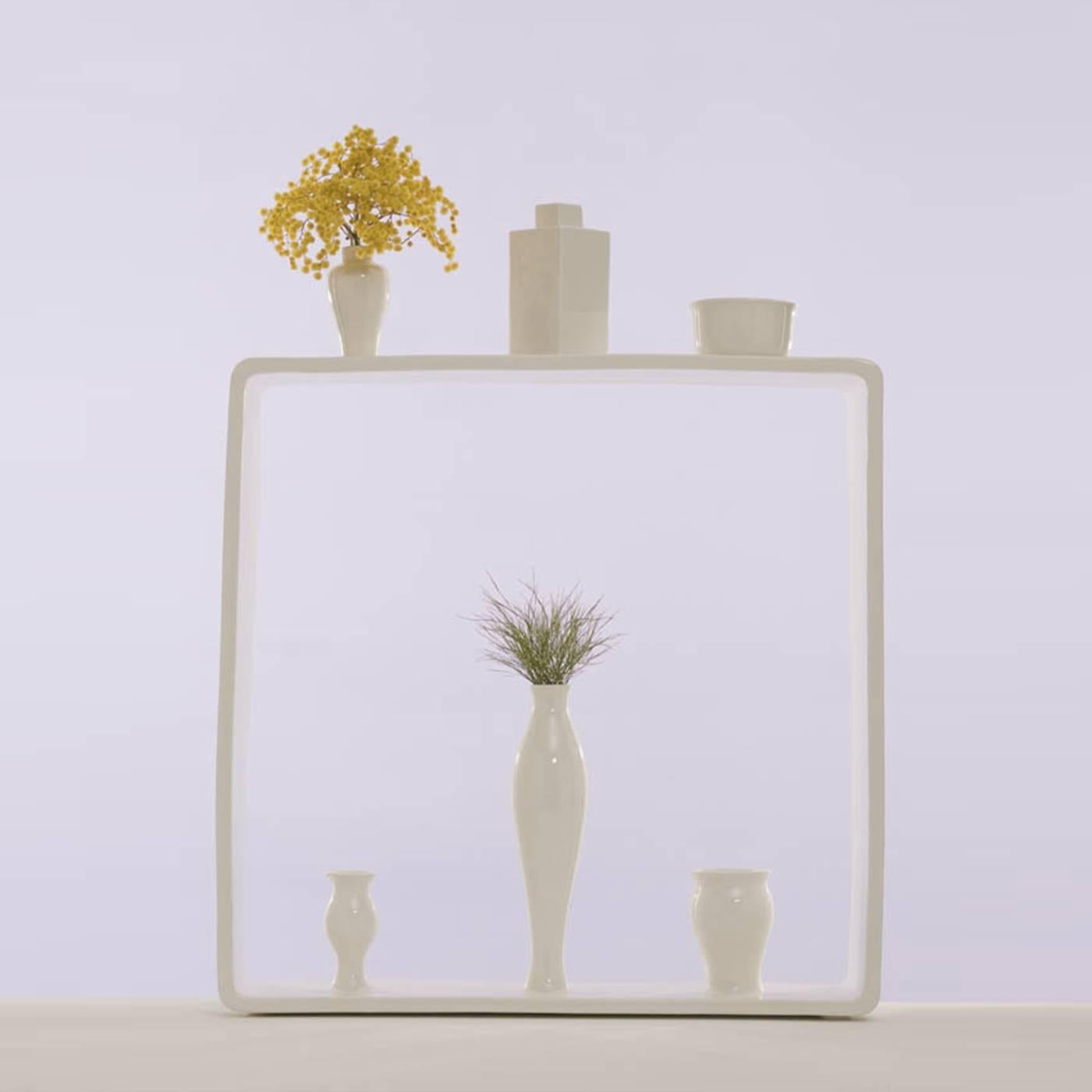 Entirely made in white ceramic, this vase is part of a limited 50-piece series, numbered and signed and created by Andrea Branzi as part of Portali, a collection of 18 vases all encapsulated within a square frame. Each vase is a micro-architecture
