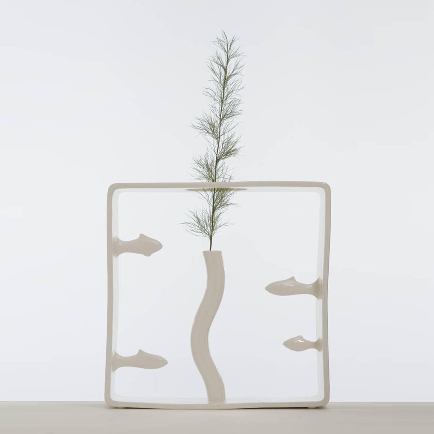 Part of the Portali collection by Andrea Branzi, this vase was made in white ceramic in a limited edition of 50 pieces that are all numbered and signed. The delicate square frame encapsulates a waving vertical vase that seems to be part of an