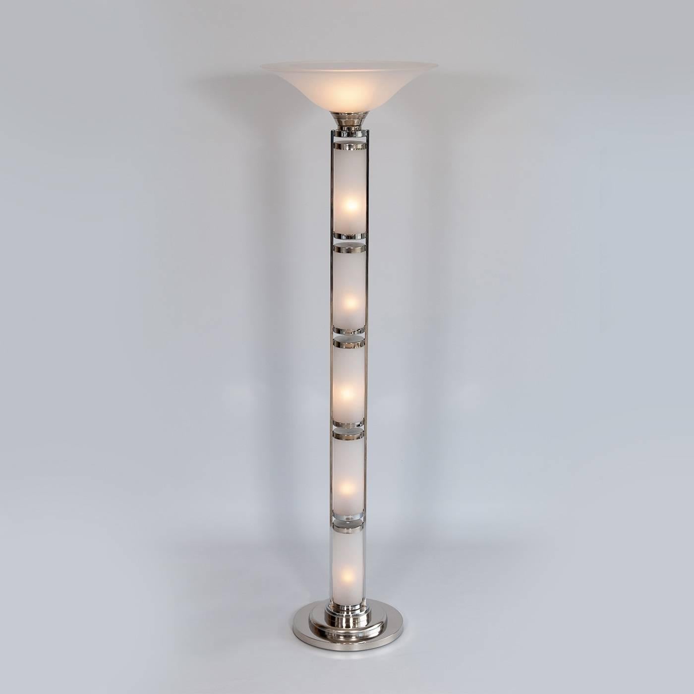 This exquisite floor lamp features a linear construction which is composed of four opaque Murano glass cylinders and a tapered conic top element. Each one of the cylinders hold a single light, and an additional light adorns the top of the piece. The
