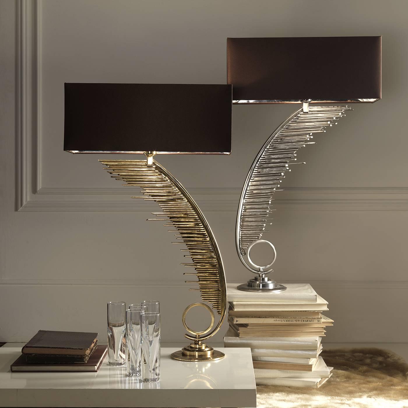 The central body of this exquisite and unique lamp consists of one sinuously curved iron rube, off of which a multitude of smaller iron tubes extend horizontally. At the base, a round platform features a circular element on its top. All iron