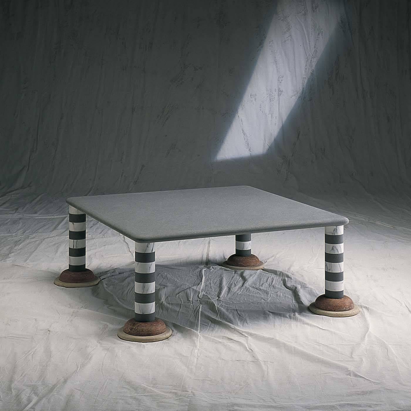 A striking, original design by Michele De Lucchi featuring a square top in pietra serena (gray sandstone) with rounded edges supported by four cylindrical legs in a striped pattern of white Carrara marble and gray sandstone. The visually striking