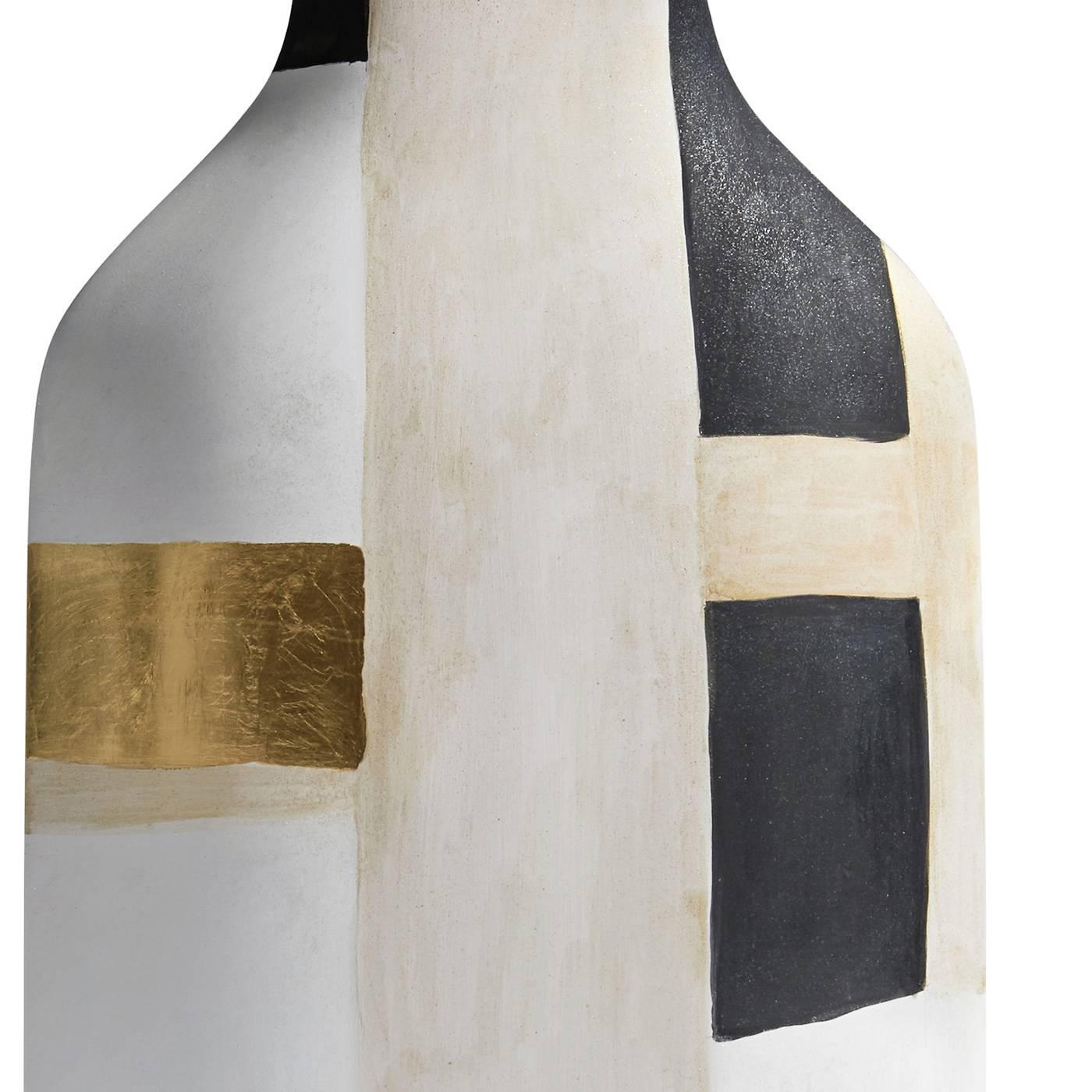 This sophisticated handmade ceramic vase features a simple silhouette and contemporary decorations that were applied by hand. Part of a limited edition of 50 pieces, this vase features a white finish with abstract black decorations and touches of