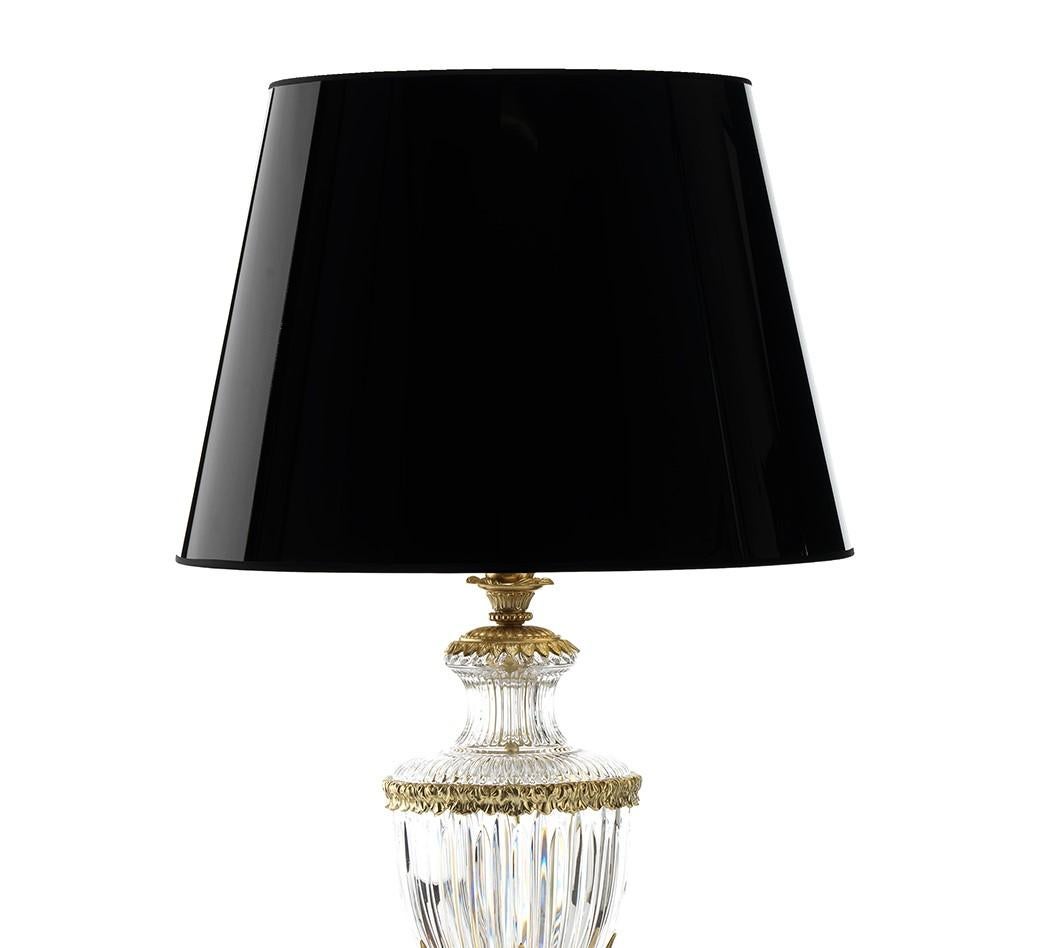 Inspired by the opulence of 18th century lighting, this striking table lamp will enliven a living room or study space with classical sophistication. Inspired by sinuous Roman amphorae, the lamp's classic silhouette rests atop a round marble base and
