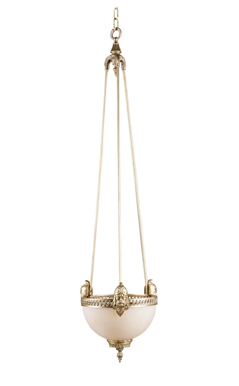 Fine detailing and refined materials distinguish this bold chandelier crafted in the neoclassic style. Bold yet balanced, elongated rods in gold-finished bronze support a semi-circular bowl fixture with an open rim with a woven, figure-8 design.