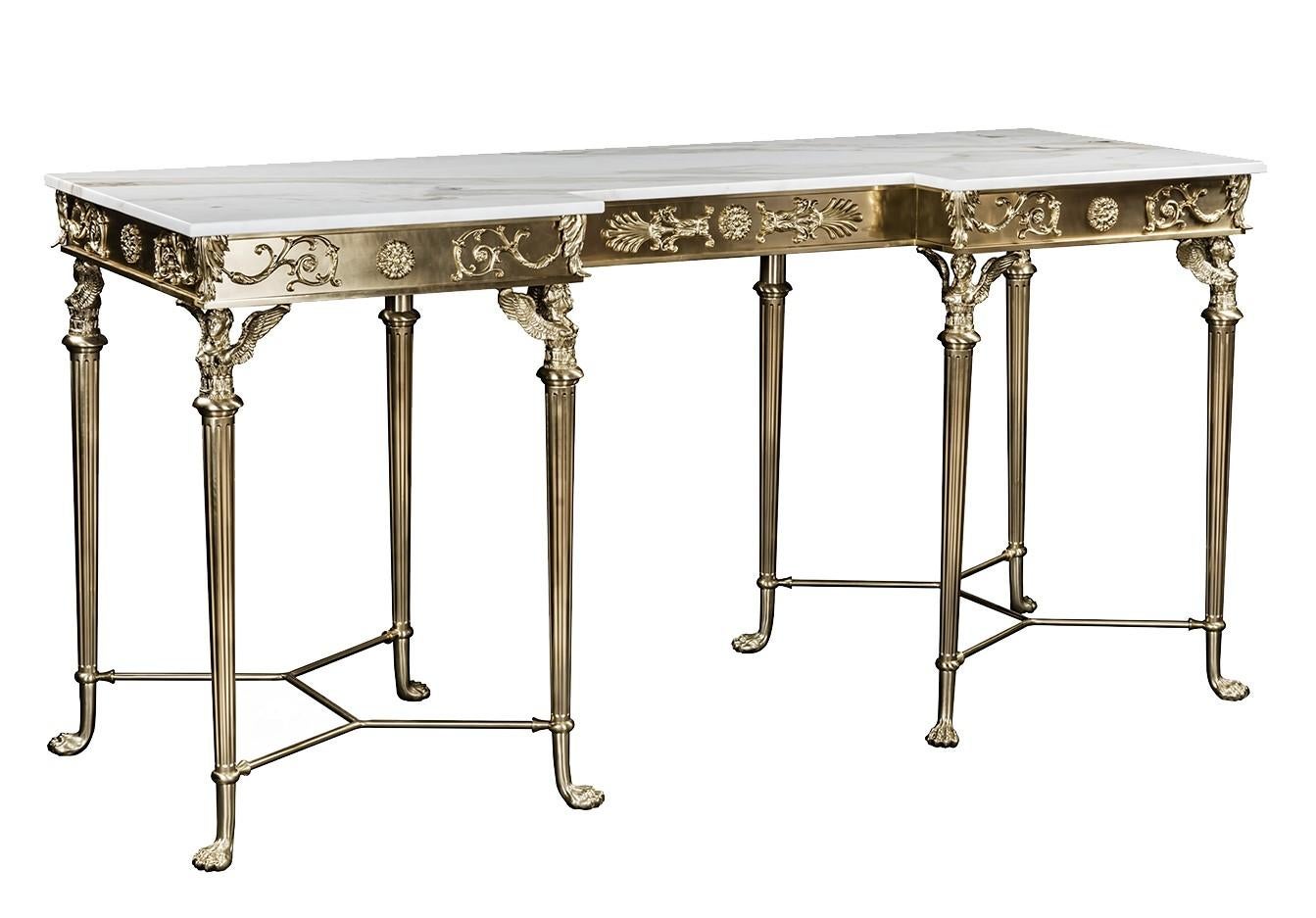 This opulent console is entirely made of bronze with natural brass finish with a striking Calacatta marble top. The neo-classic inspiration is revealed in the tapered pad legs with an upper winged sphinx decor and stylized hourglass stretchers, and