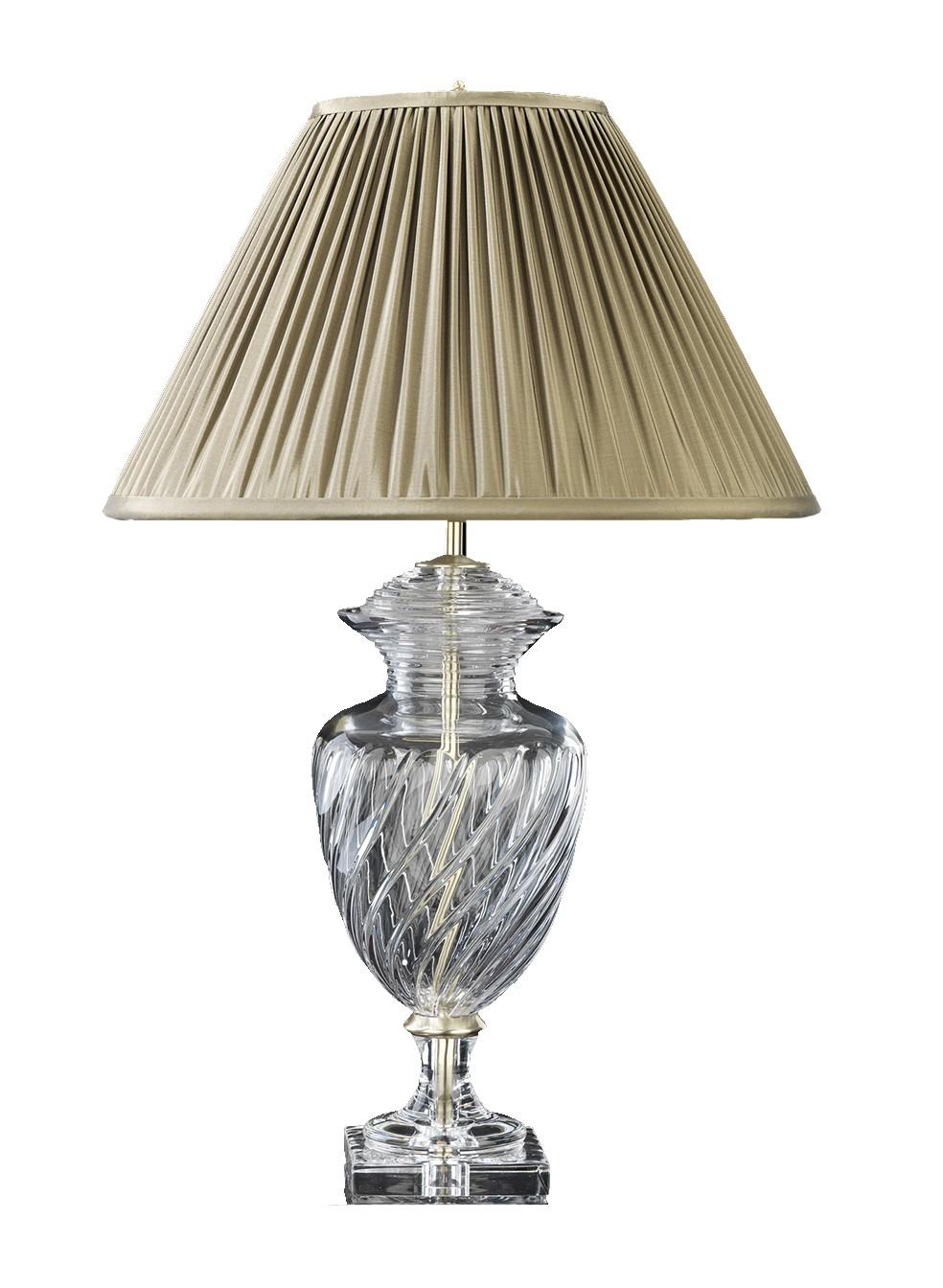Evoking the glamour of 18th century French neoclassicism, this lavish table lamp is entirely made of handcut crystal. The sinuous silhouette, reminiscent of Classic Roman amphorae, is enhanced by delicate ridges on the glass, gracefully swirling