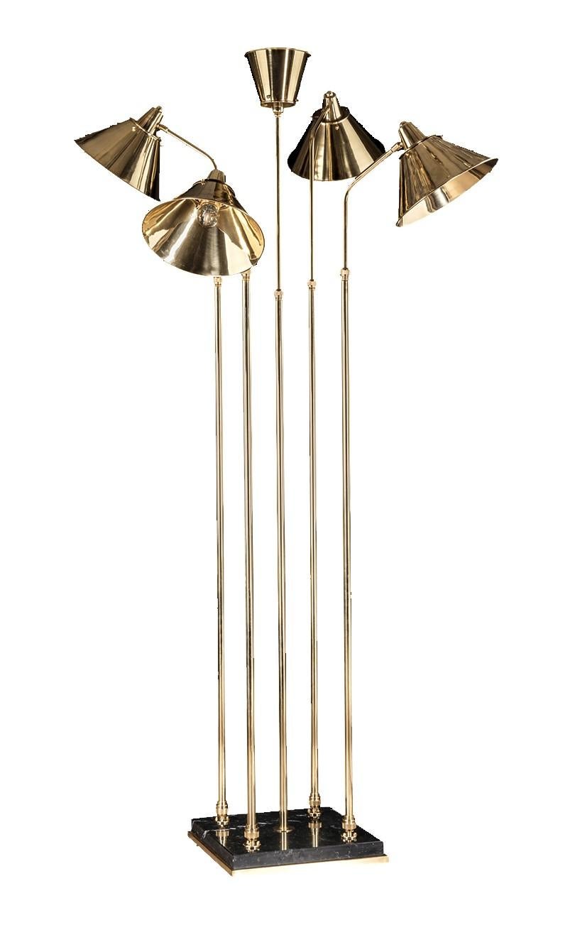 This floor lamp will be the spotlight in a formal dining area, in a corner, or behind a sofa. Made entirely of brass with French gold finish, this exquisite lamp features a Minimalist brass and marble base with five slim columns with conical shades