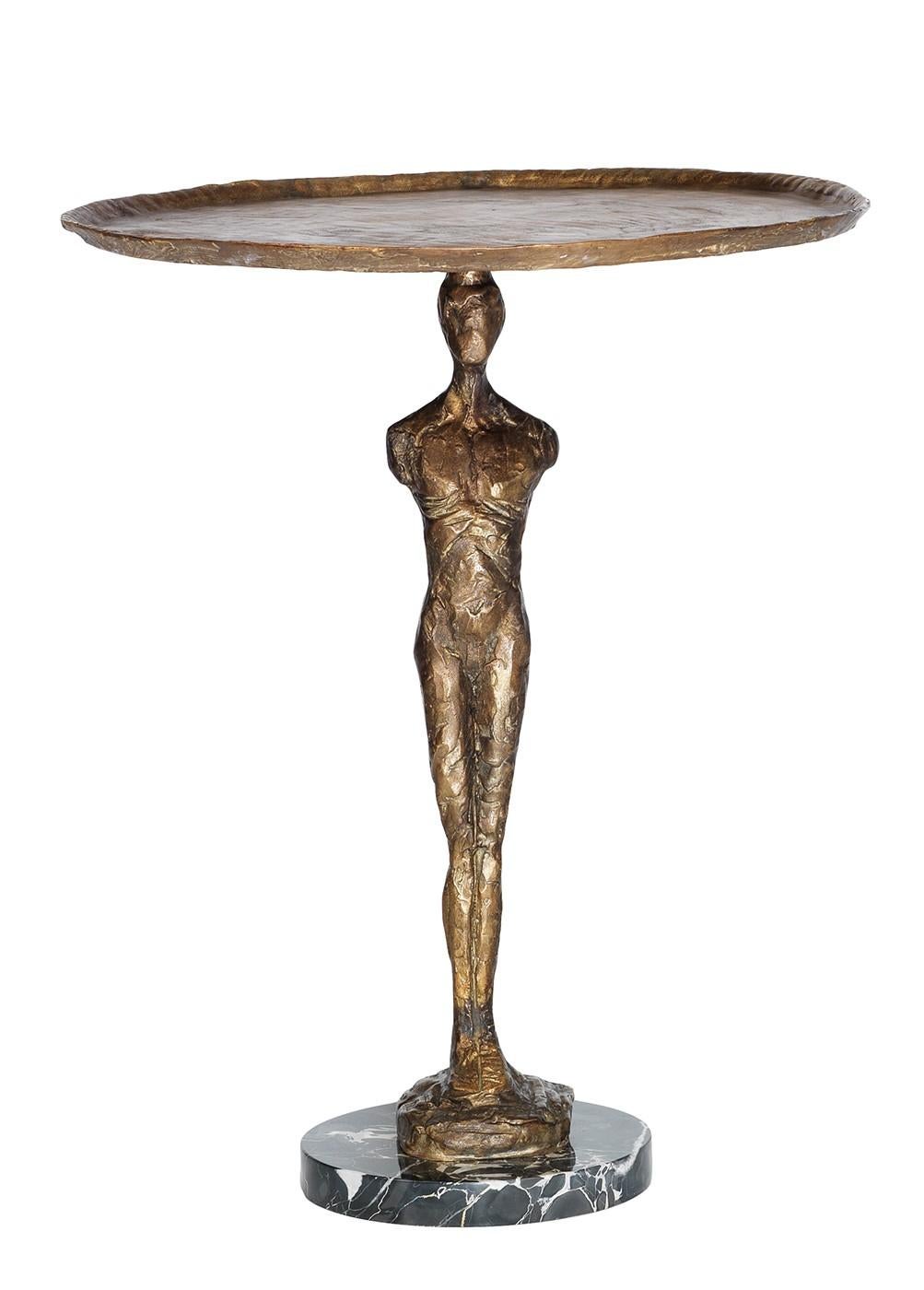 Evoking the simplicity and elegance of neoclassic designs, this table will add a sophisticated touch to any decor. The balanced design features a beveled tray supported by the athletic Silhouette of a man reminiscent of ancient Greek statuary. The