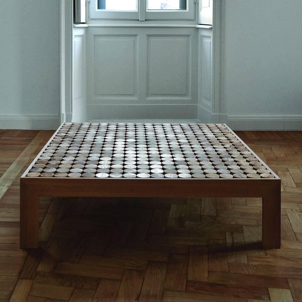 This striking coffee table was made in solid wood by expert carpenters and, because it was made using artisanal methods, each piece is a one-of-a-kind object numbered and signed. Its structure rests on solid wood legs (that can also be in polished