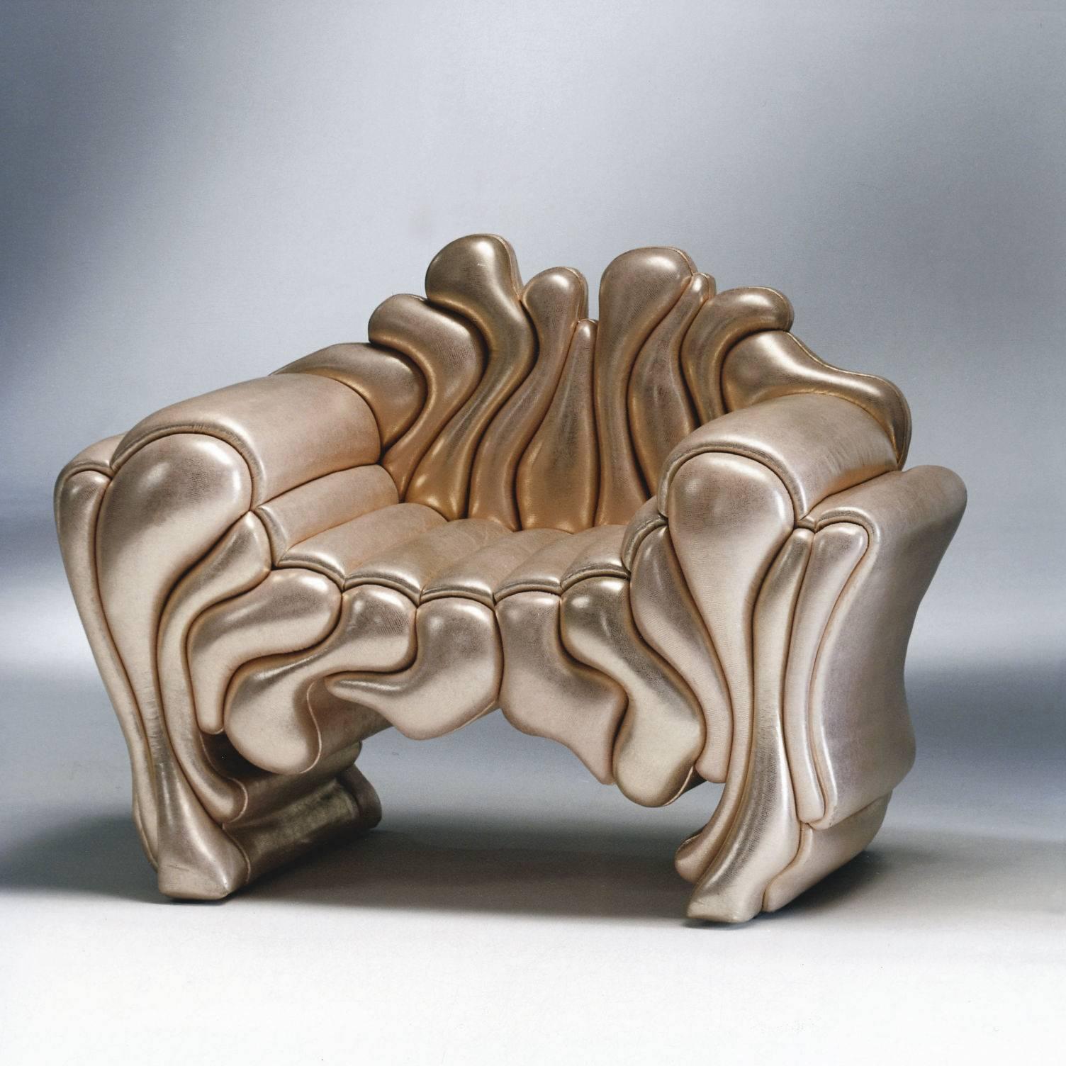 This armchair, designed by Roberto Fallani, features a wooden structure covered in a series of foam cushions of different irregular shapes and sizes and all upholstered in leather. Strikingly evoking melted lava slowly pouring off a surface, this