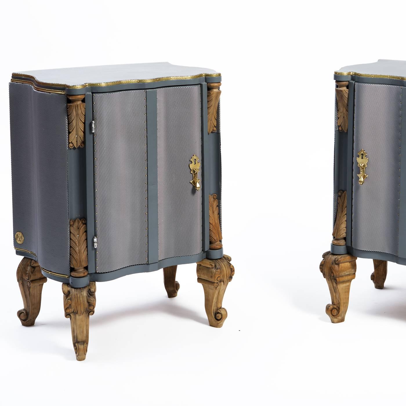 Inspired by ancient chainmail, these striking nightstands are partially covered in an iron mesh that envelops them while emphasizing their simple Silhouette and sinuous accents. The original gilt details around the top edges and antique carved