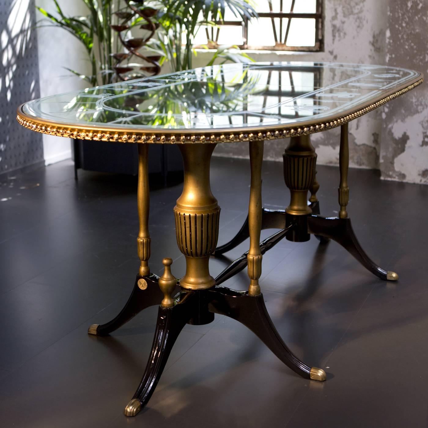 The elliptical top of this elegant table evokes the eternal passing of time, with no beginning and no end. Figurines representing the zodiac symbols are etched around the ellipsis, while gilt skulls illuminate the edges, symbolizing the passing of
