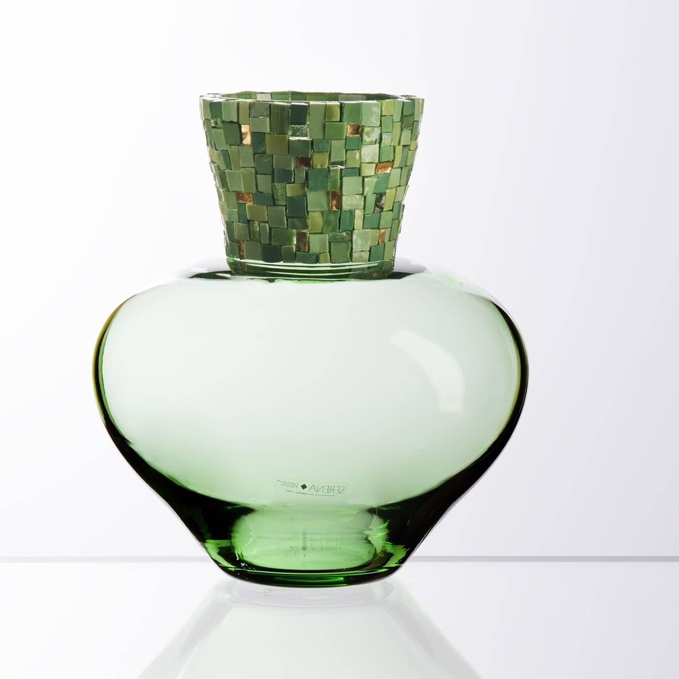 The smooth, round shape of the vase is heightened by the tactile juxtaposition of mosaic accents on its neck that creates a vibrant, gleaming texture. Made of Murano mouth-blown glass in a pale shade of green, this elegant vase features a