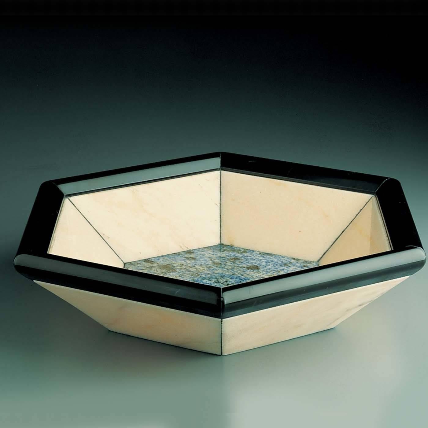 A truly exquisite object of functional decor, this handcrafted, versatile object has an hexagonal sodalite base with six trapezoidal panels in pink Rosa Portogallo marble extending outwardly and a bold rim of black Belgio marble. The geometric shape