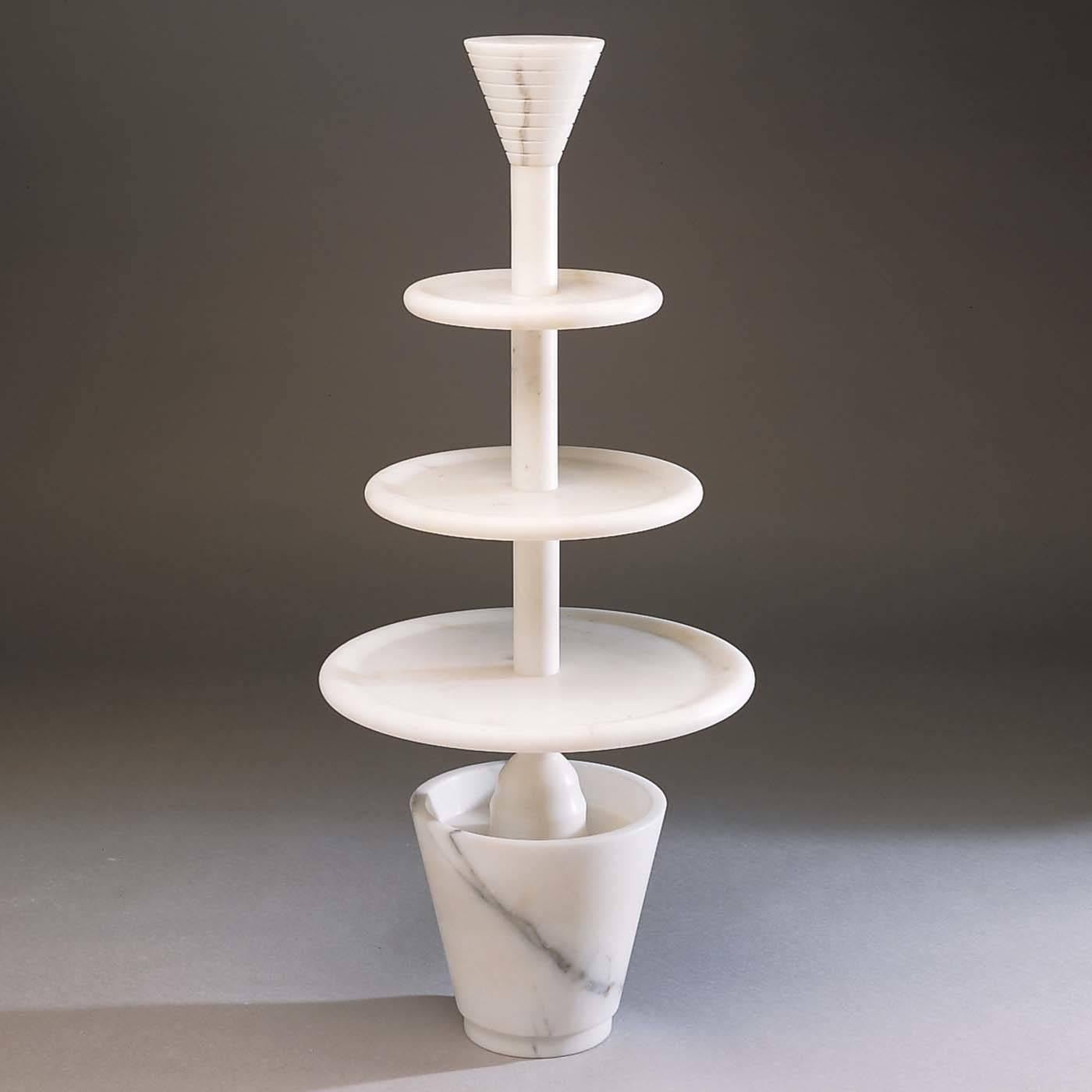 An immaculate design that conveys the high aesthetic quality of marble with its bare, monochromatic Silhouette. Designed by Ugo La Pietra in 1987, this striking three-tier cake stand is a unique way to serve hors d'oeuvres, fruit, or desserts in
