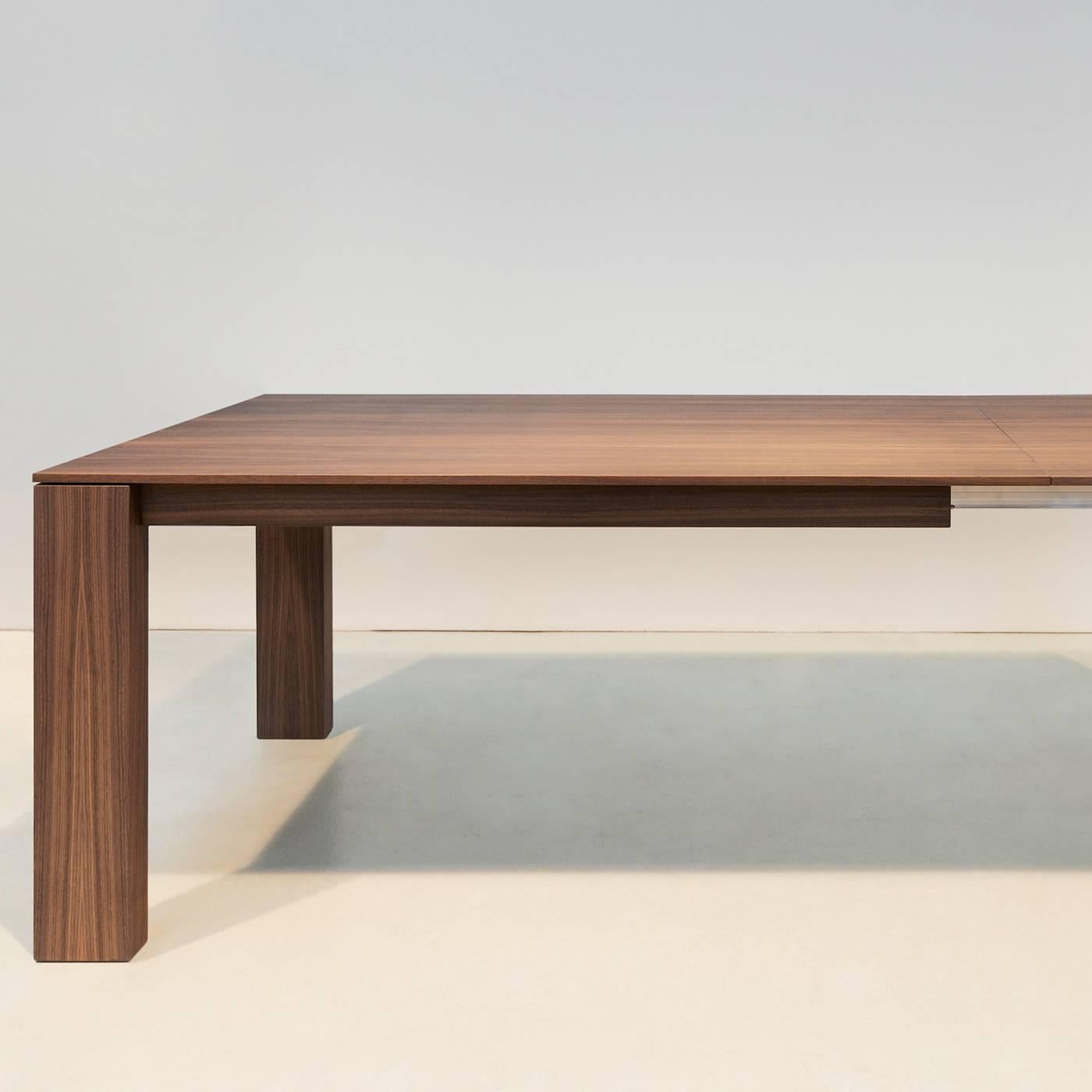 The exquisite Minimalist design of this handcrafted table with subtle, refined details is Frigerio's trademark. Made of Canaletto walnut veneer, the singularity of this table is its ultra-slim solid tabletop, measuring just 15mm, that can be