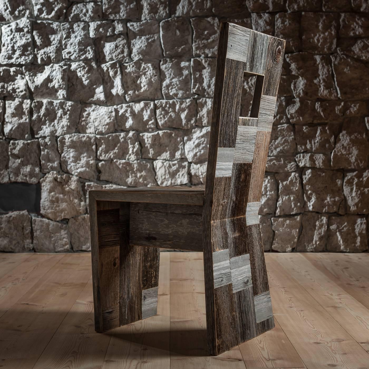 Inspired by the Tofana di Rozes mountain of the Dolomites, located west of the resort of Cortina d'Ampezzo, famous for its giant three-edged pyramid shape and its vertical south face, this massive and angular chair is made of squares of antique,