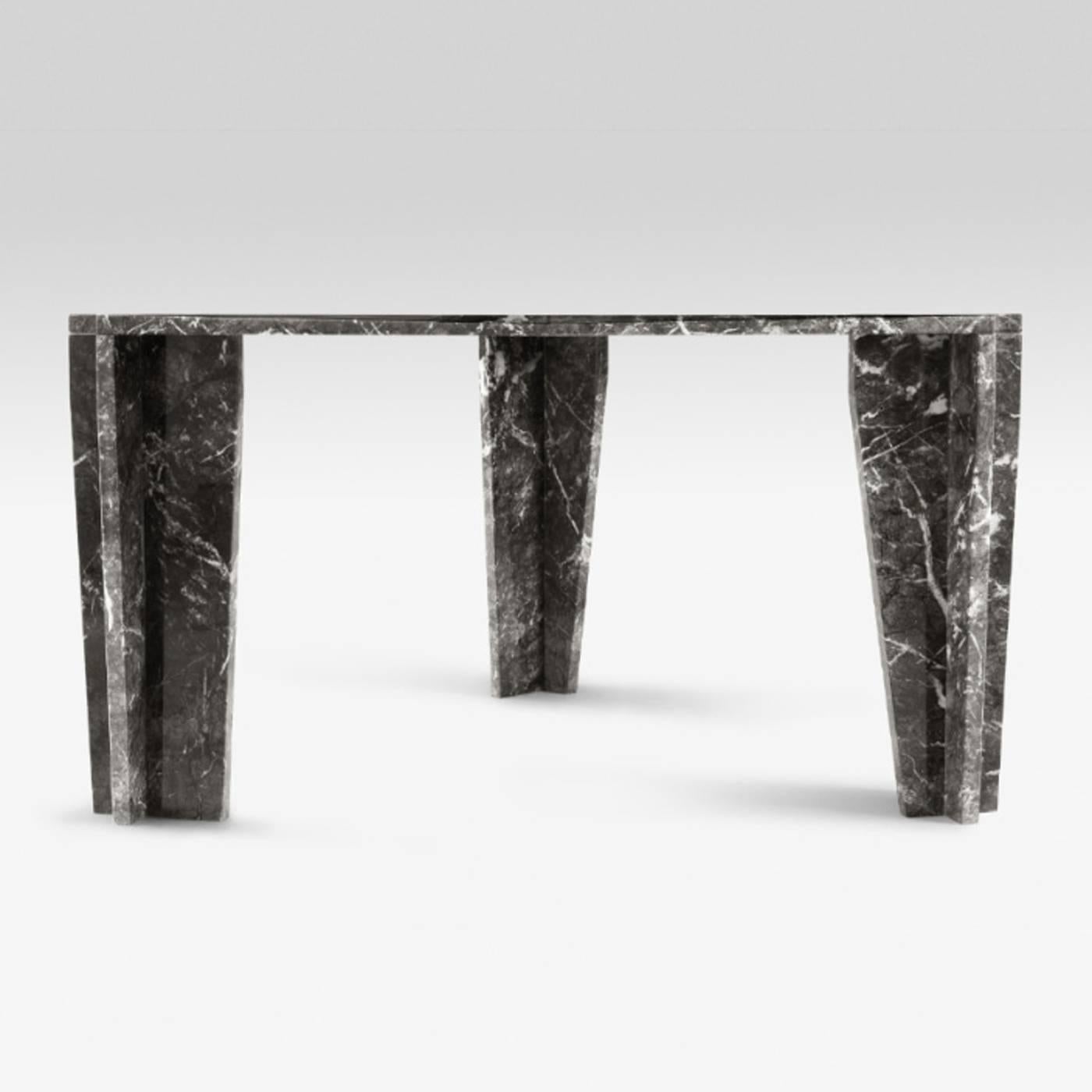 This striking table is entirely made in grey Carnico marble that is 3 cm thick. It accommodates six guests and it features three legs, connected to the top with a joint that doesn't use glue or screws. The marble can be changed with green Guatemala,
