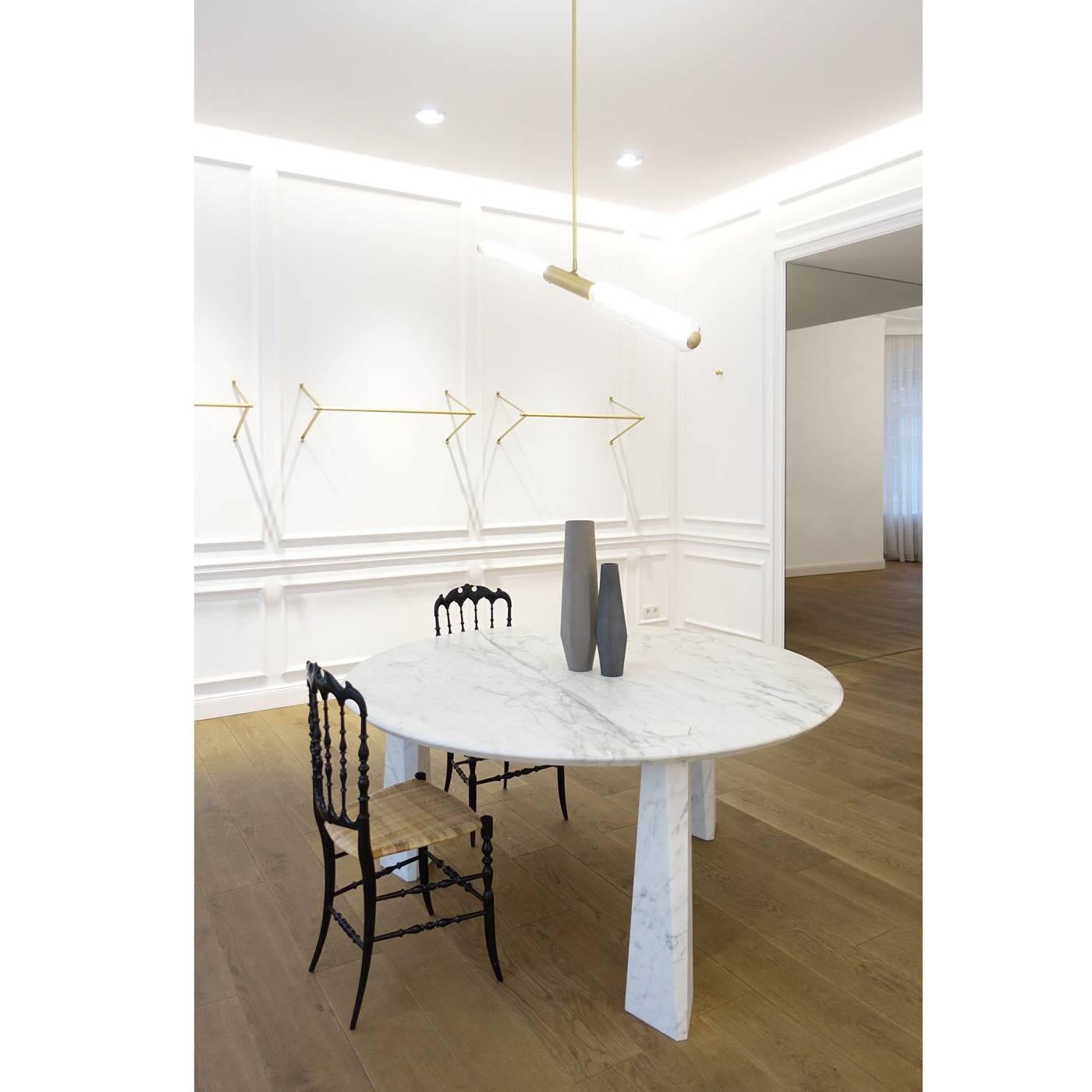 This superb dining table for six people features only three legs. It is executed entirely in white Carrara marble with a 4cm. thick top plate. The M series features a hexagonal sloping joint without the use of glue or screws. Upon request, the